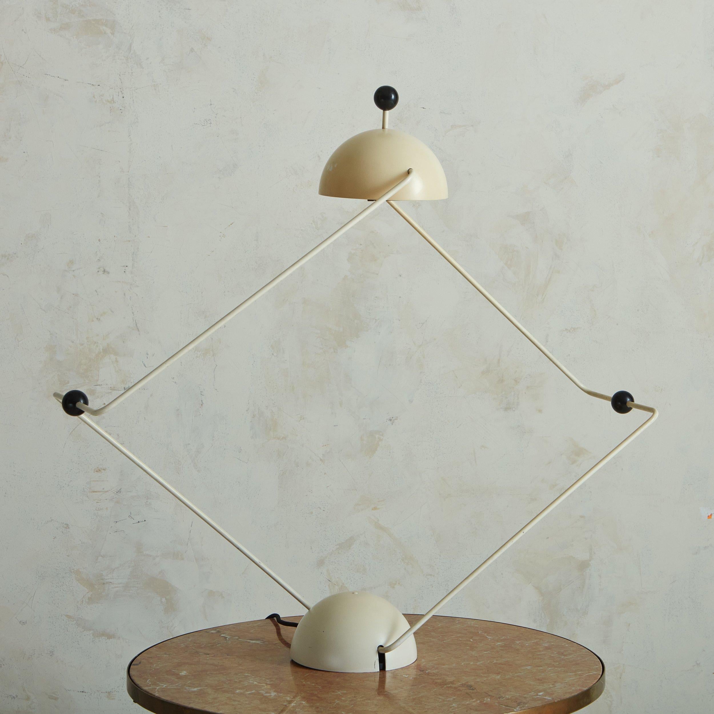 A vintage 1970s adjustable table lamp with striking parallels to early designs by Paolo Piva. The lamp has an original ivory finish to a metal frame with black accents. At full extension, it stands at 44”.
  
 DIMENSIONS: 8”W x 41”D fully extended x