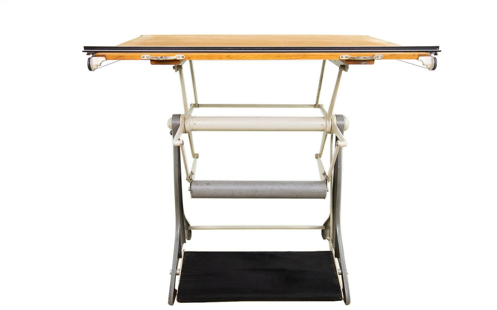 Architects table 

An Admel adjustable draughtsman's table/drawing board.

This mid-century British made draughtsman's table features a tilt table above a solid metal frame.

The top can be tilted, lifted and secured as you wish using the