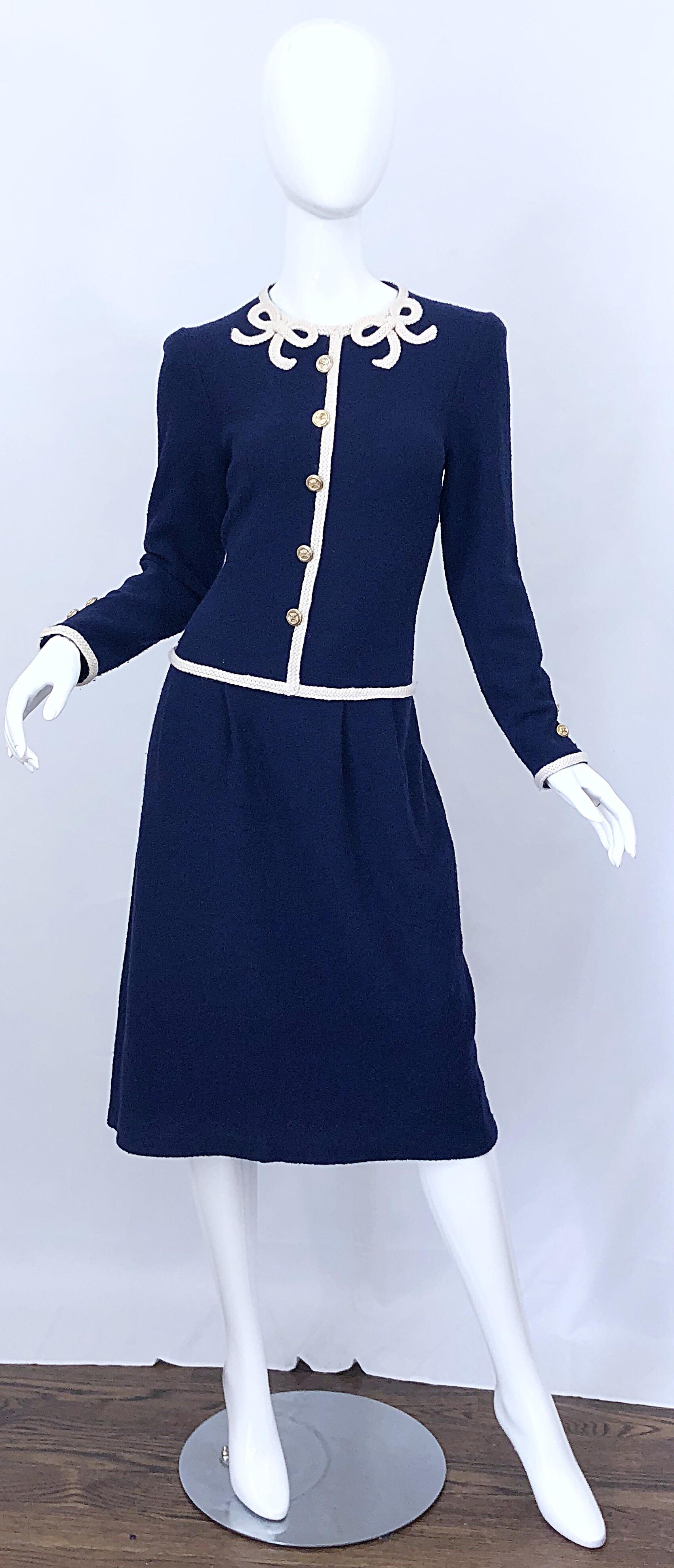 Chic vintage ADOLFO for SAKS FIFTH AVENUE navy blue and ivory knit long sleeve embroidered dress! Features a soft navy blue knit with ivory white embroidery throughout. Bows sewn at each side of the neck. Hidden zipper up the back with 
hook-and-eye