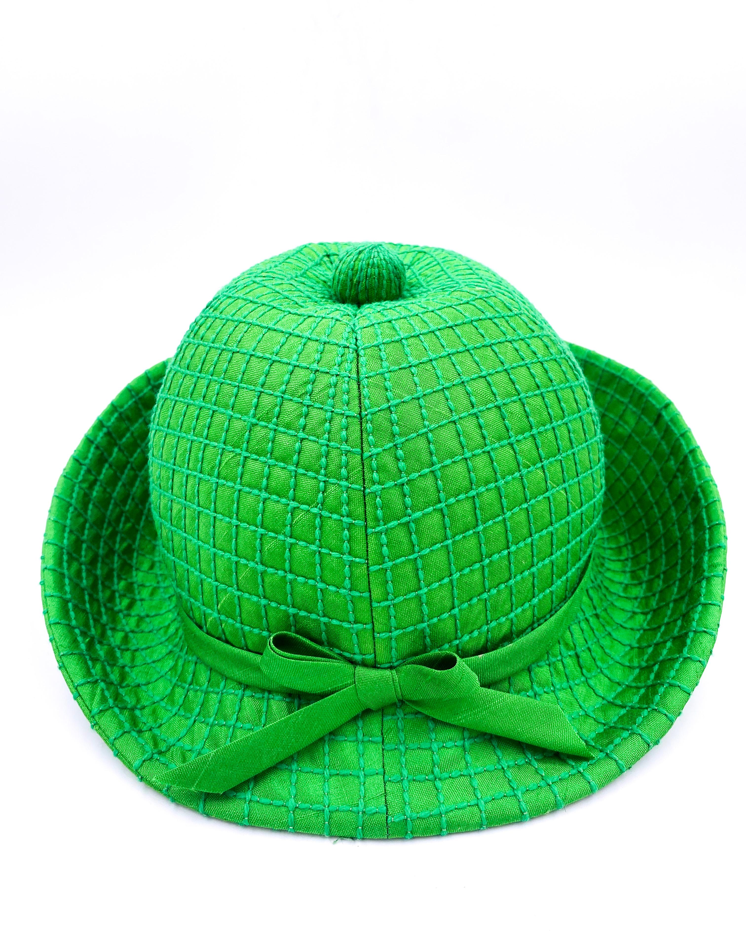 Add a pop of color to your wardrobe with this vintage Adolfo Kelly Green Hat. Featuring a quilted design, a vibrant kelly green color, and a charming bow on the front, this hat is sure to make a statement. Plus, it comes with a personalized note and