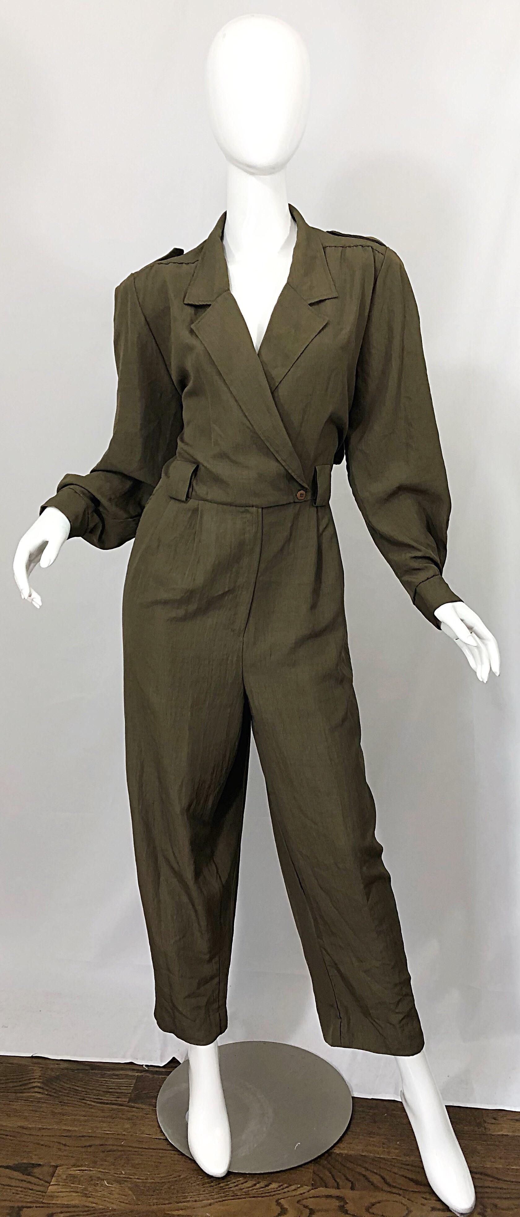 Stellar vintage ADOLFO army green military inspired jumpsuit in hard to find Size 16 ! Double breasted style with buttons at left waist, and interior right waist. Zipper crotch. Relaxed style pants offer comfort and style. Anchor embossed brass
