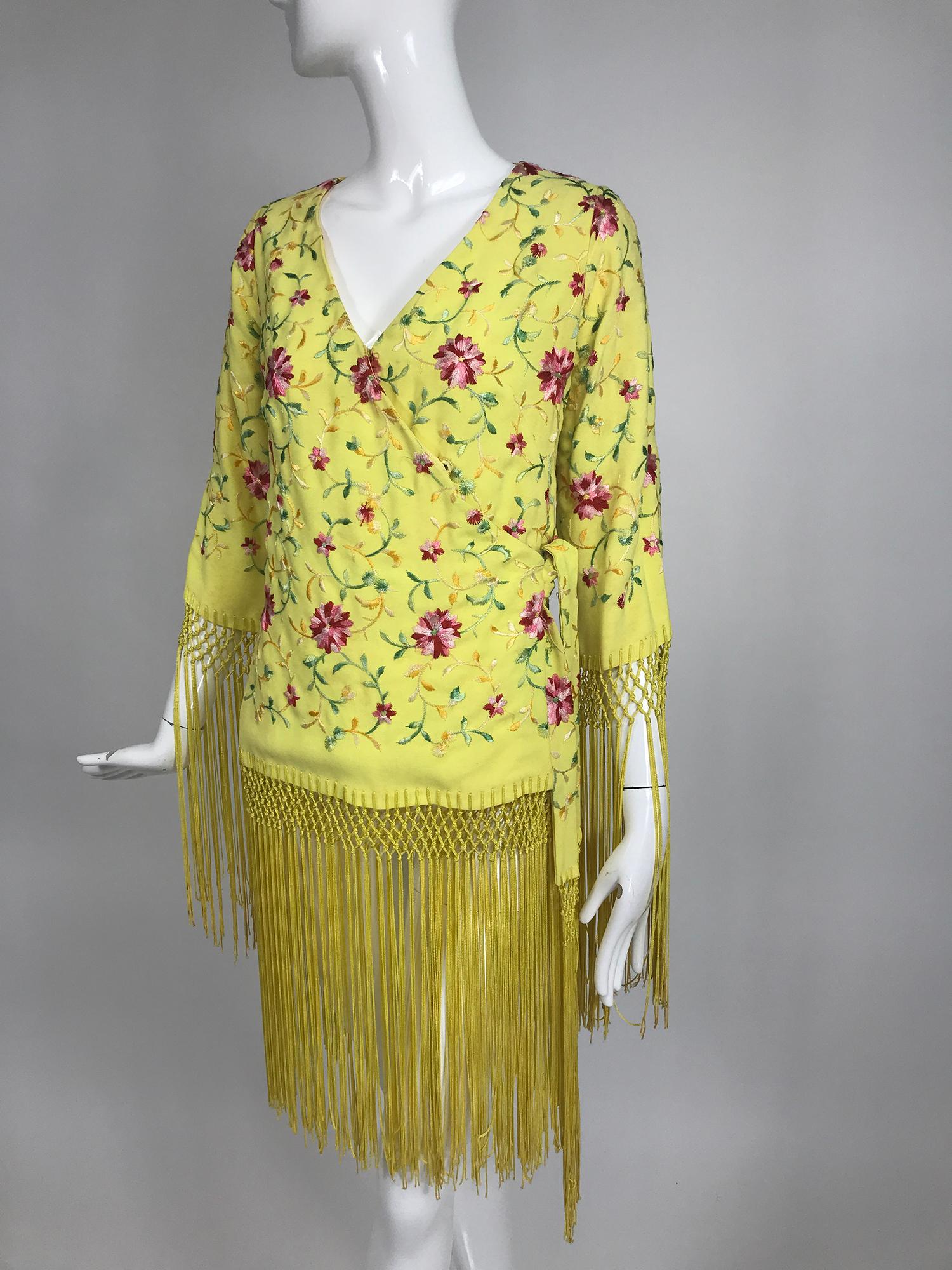 Vintage Adolfo yellow embroidered fringe trim wrap jacket tunic from the 1970s. Yellow embroidered crepe wrap jacket tunic with a V neckline, has long sleeves with macrame and long sliky fringe trim, the hem is trimmed the same. Wraps and closes at