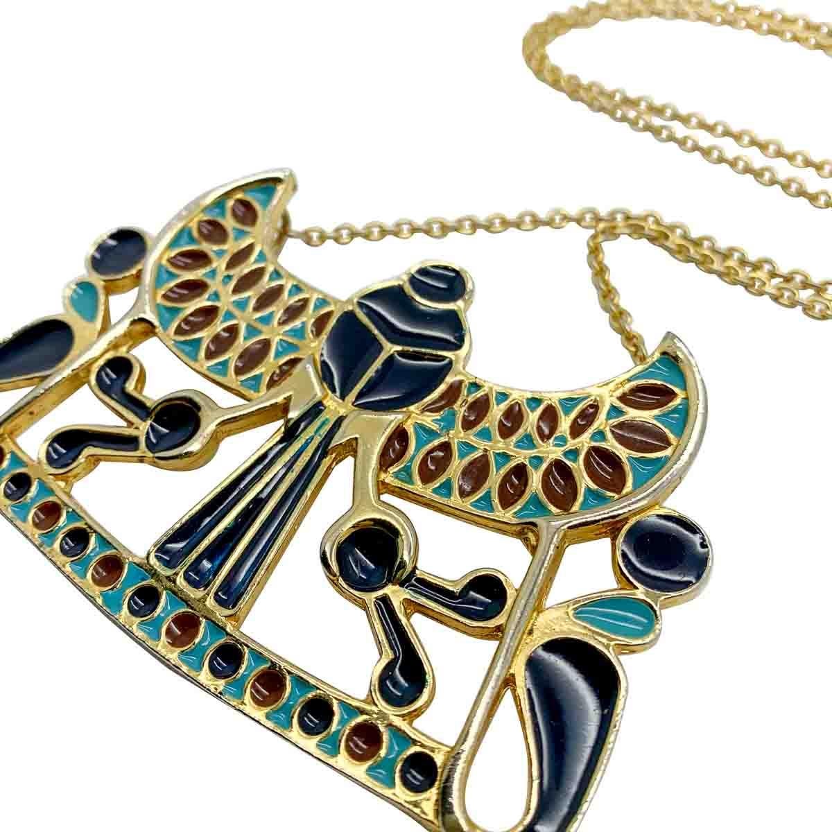 A striking vintage Egyptian plaque necklace by Adrian Mann, London during the 1970s. Featuring an impressive Egyptian revival motif decorated with contrasting enamelled colours of deep blue, turquoise and brown.

Vintage Condition: Very good without