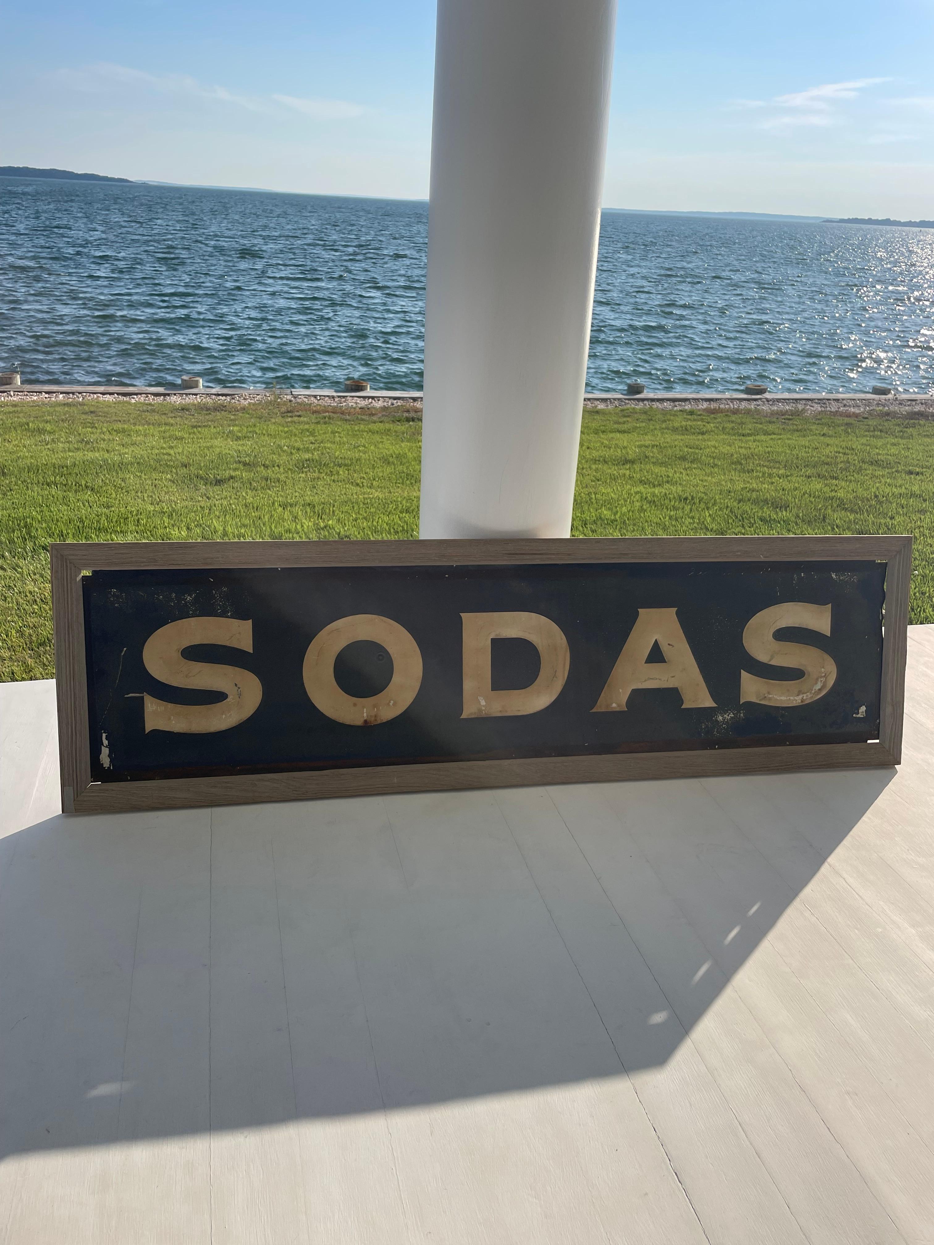 Great looking rare original large size embossed metal advertising “SODAS” sign..Looks like it came from an old country mom and pop store . All metal with a wooden frame and ready to hang easily . Perfect to add some charm to your home or business.