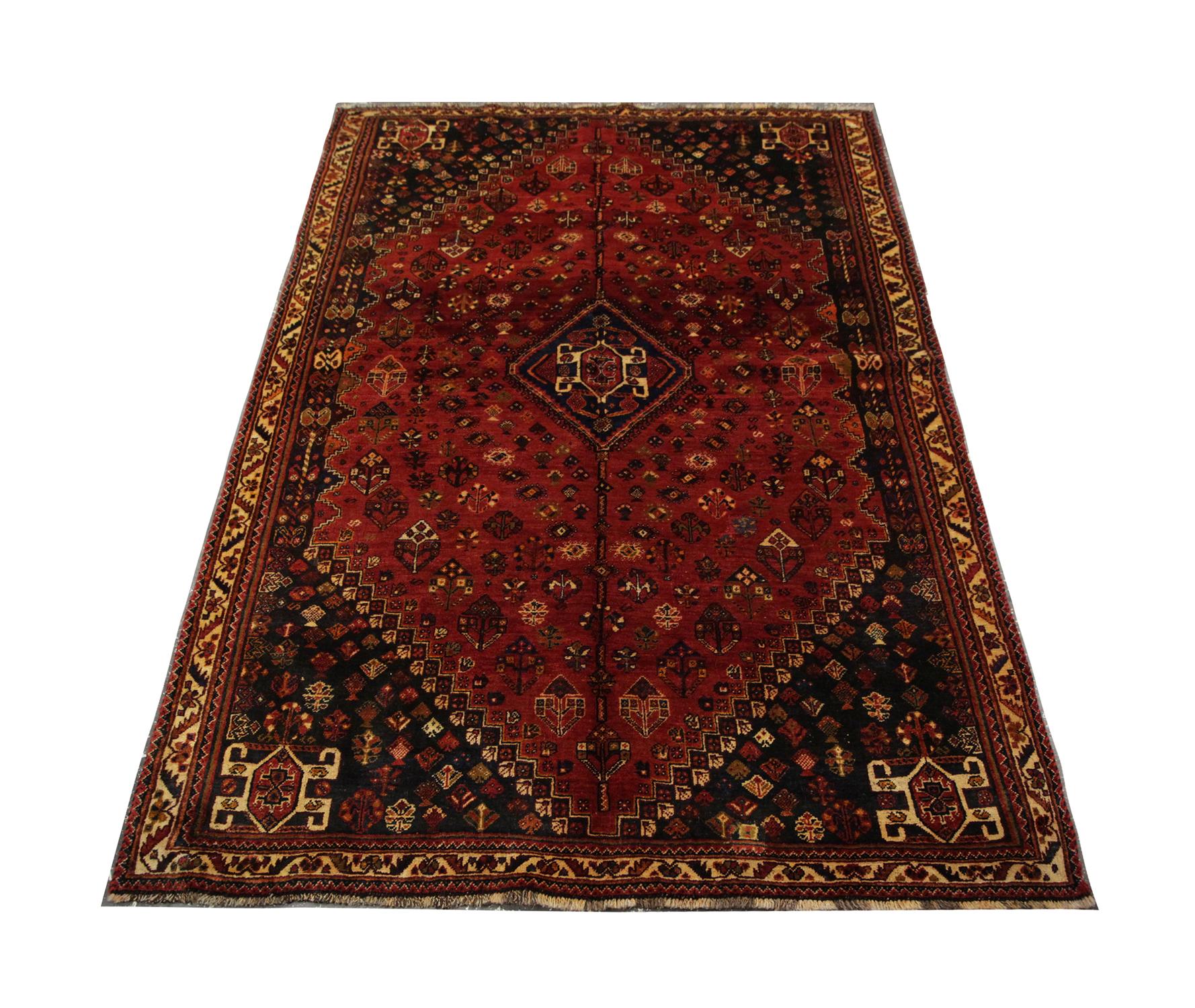 Deep rich tones have been used in the construction of this highly decorative tribal rug. Featuring a central medallion on a burnt orange/ red background surrounded by intricate motif details and a border with just as much rich detailing. This