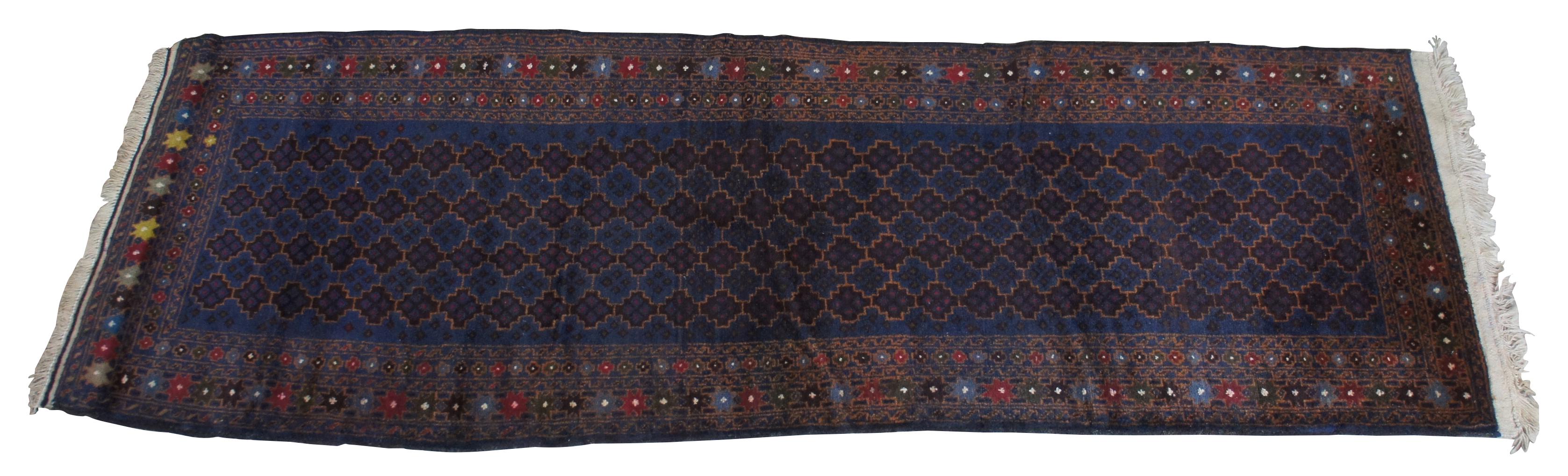 Mid 20th century wool nomadic Kazak rug from Afghanistan. Features a field of blue with geometric design and colorful border of 8 point stars.
  