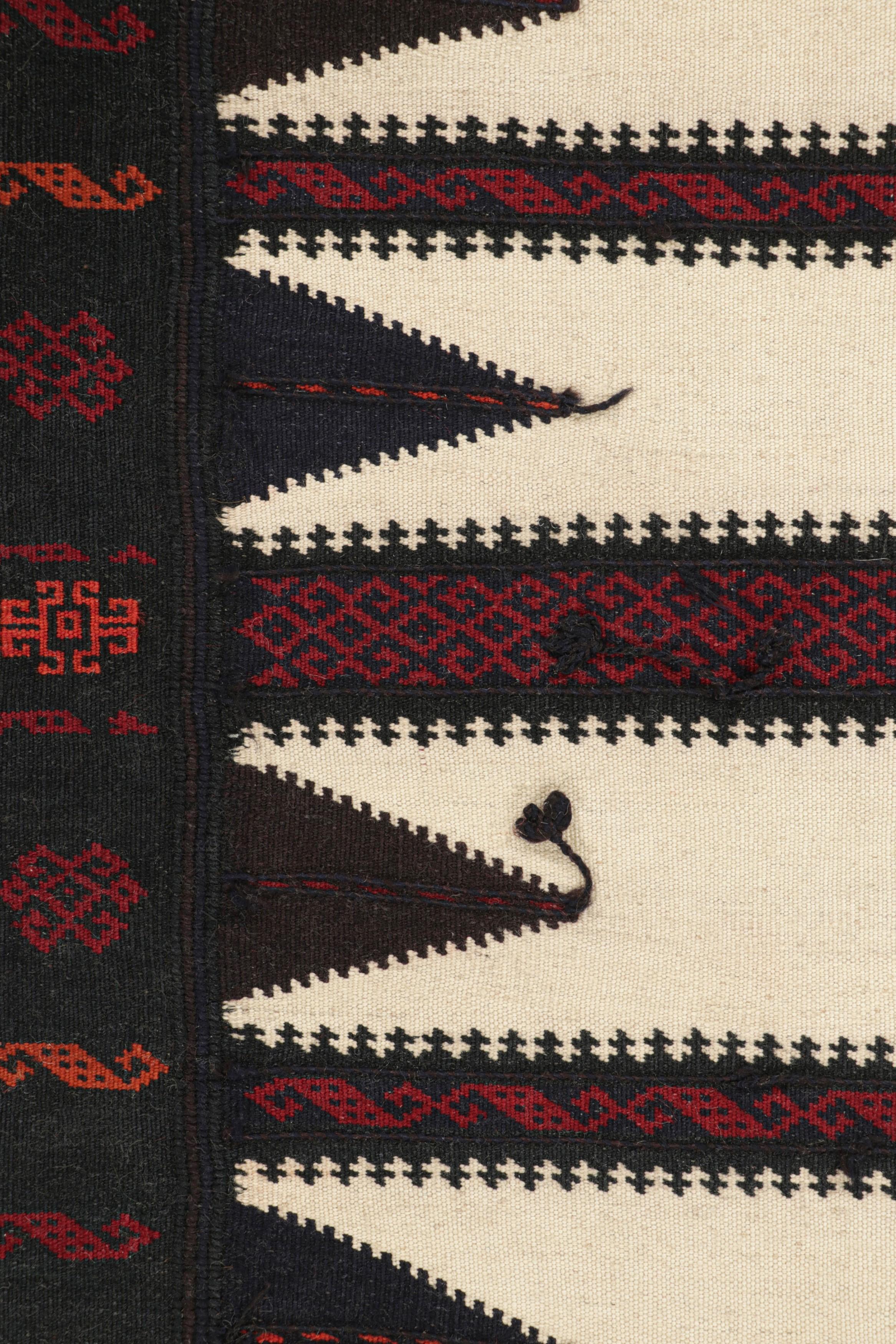 Hand-woven in wool, circa 1950-1960, this 2x4 vintage Afghan kilim is a rich tribal piece that may have been used as table covers in nomadic daily life, much similar to Persian Sofreh Kilims.

On the Design: 

A striking relic of tribal artistry,