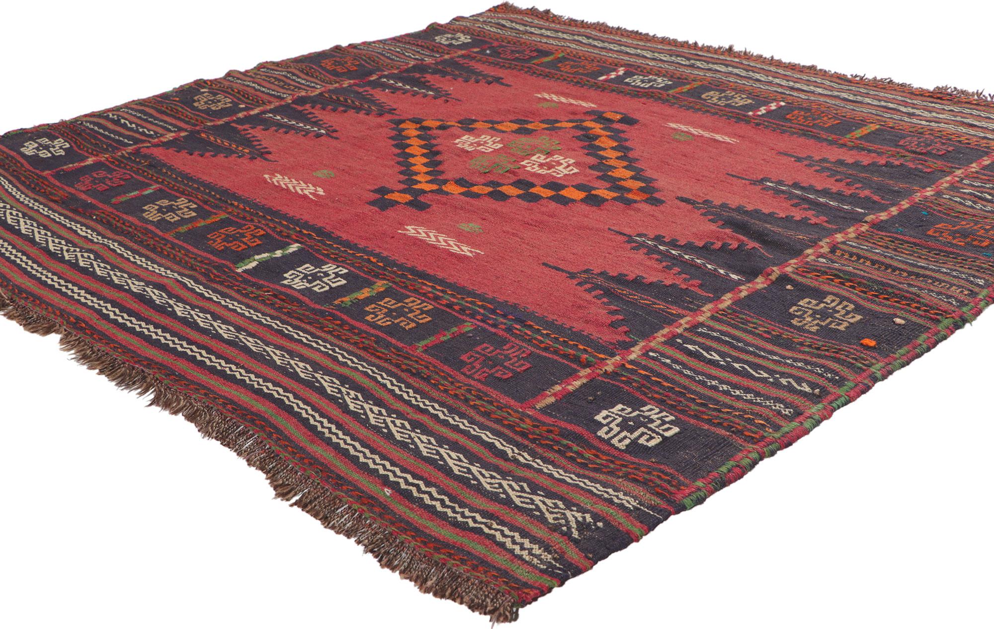 61142 Vintage Afghan Kilim rug, measures 04'06 x 04'04.
Full of tiny details and nomadic charm, this handwoven wool vintage Afghan kilim rug is a captivating vision of woven beauty. The eye-catching tribal design and warm earth-tone colors woven