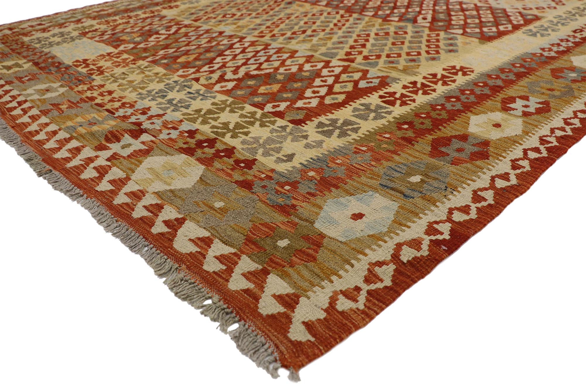 80160 Vintage Afghani Kilim Rug, 06’08 x 09’05. In this handwoven wool vintage Afghan kilim rug, Contemporary Santa Fe style merges seamlessly with tribal enchantment, offering a captivating design and culture. The rug's striking tribal motifs and
