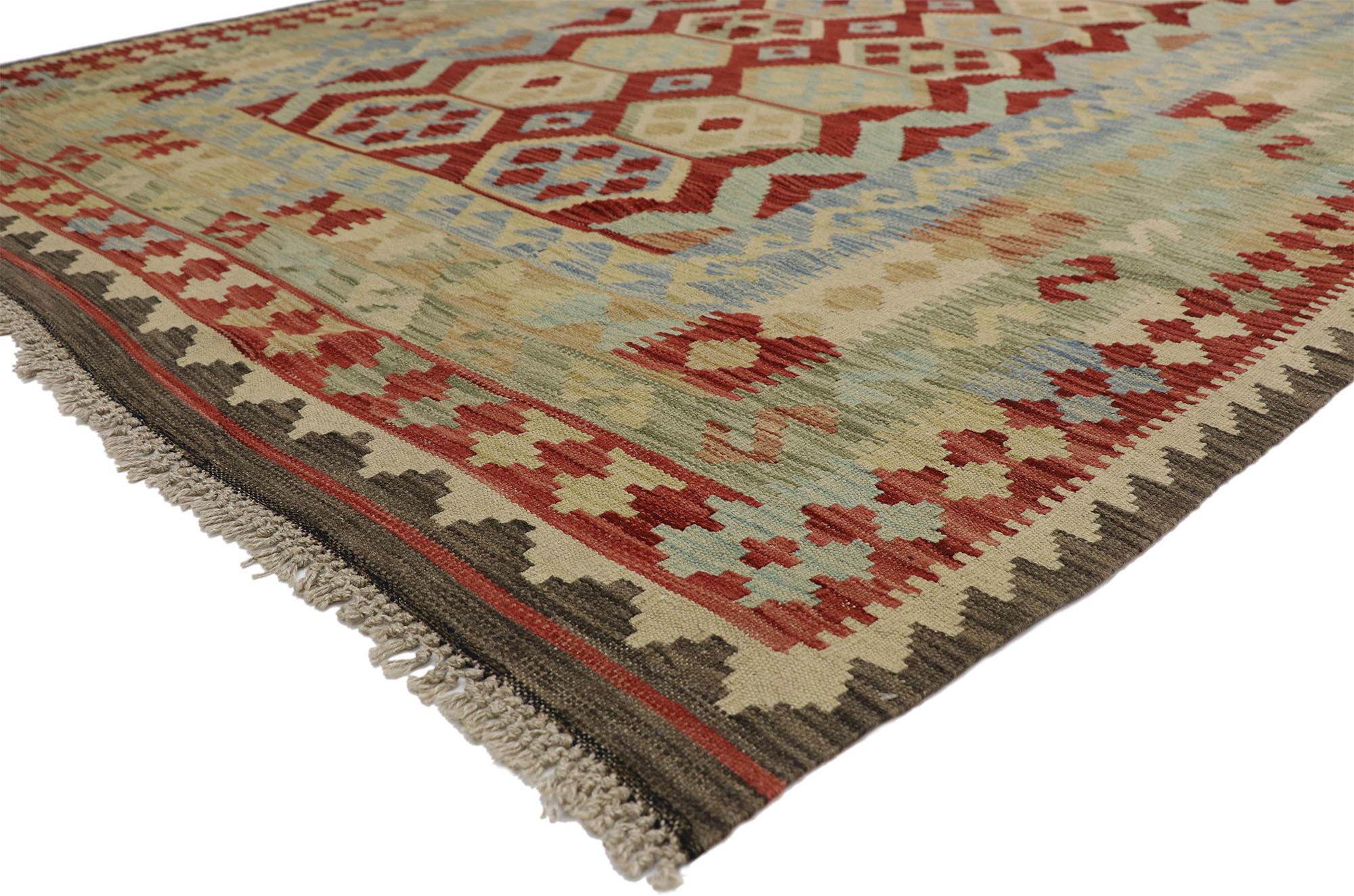 80119 Vintage Afghani Kilim Rug, 06’09 x 09’07. In this handwoven wool vintage Afghan kilim rug, the essence of Southwest Modern style intertwines seamlessly with tribal allure. Bold tribal motifs and vibrant earth-tone hues converge, fashioning a
