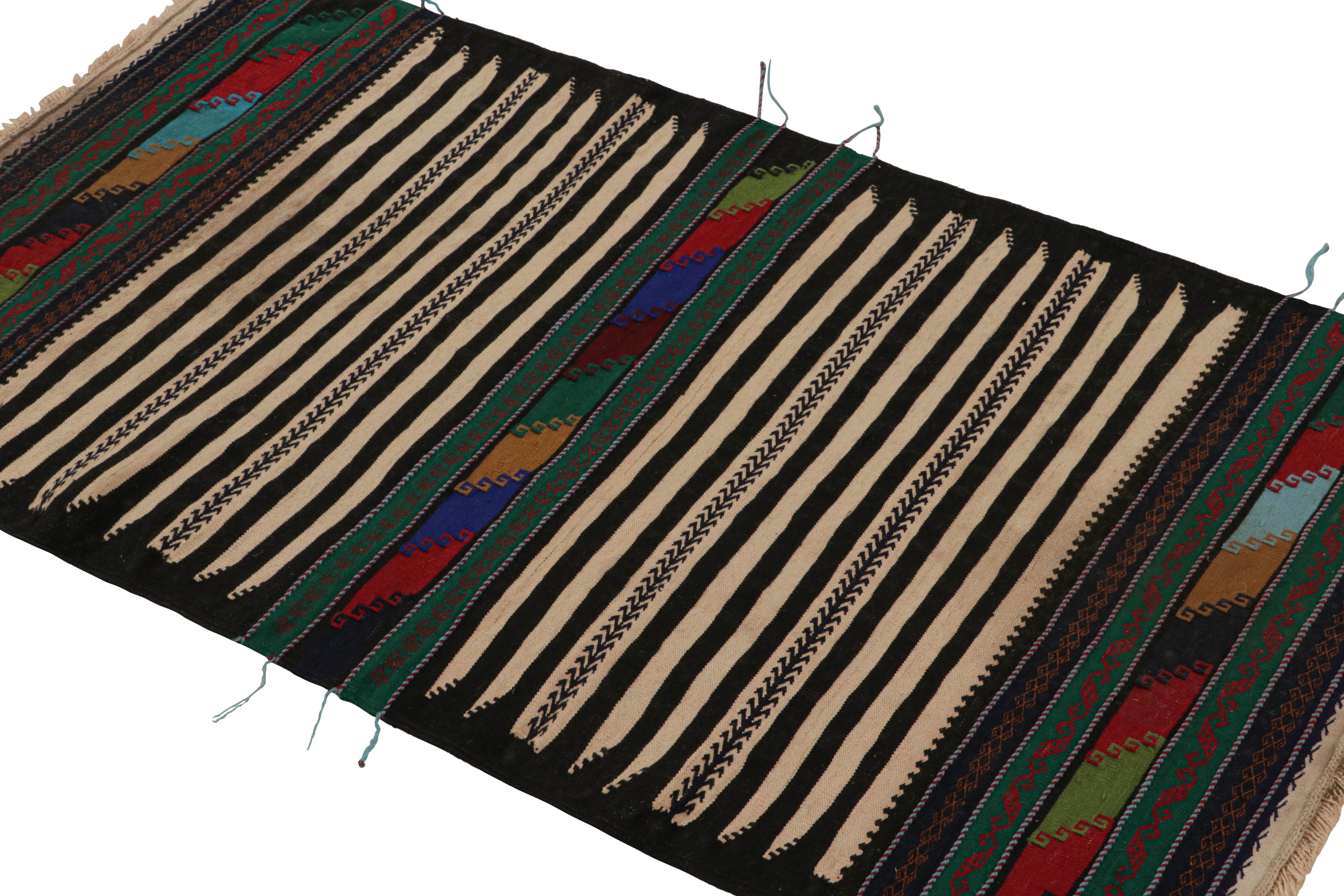 Handwoven in wool, this 3x4 vintage Afghan kilim rug originates circa 1950-1960—a tribal curation among new additions to the Rug & Kilim collection.

On the Design:

A polychromatic colorway with both rich and vibrant hues underscores both stripes