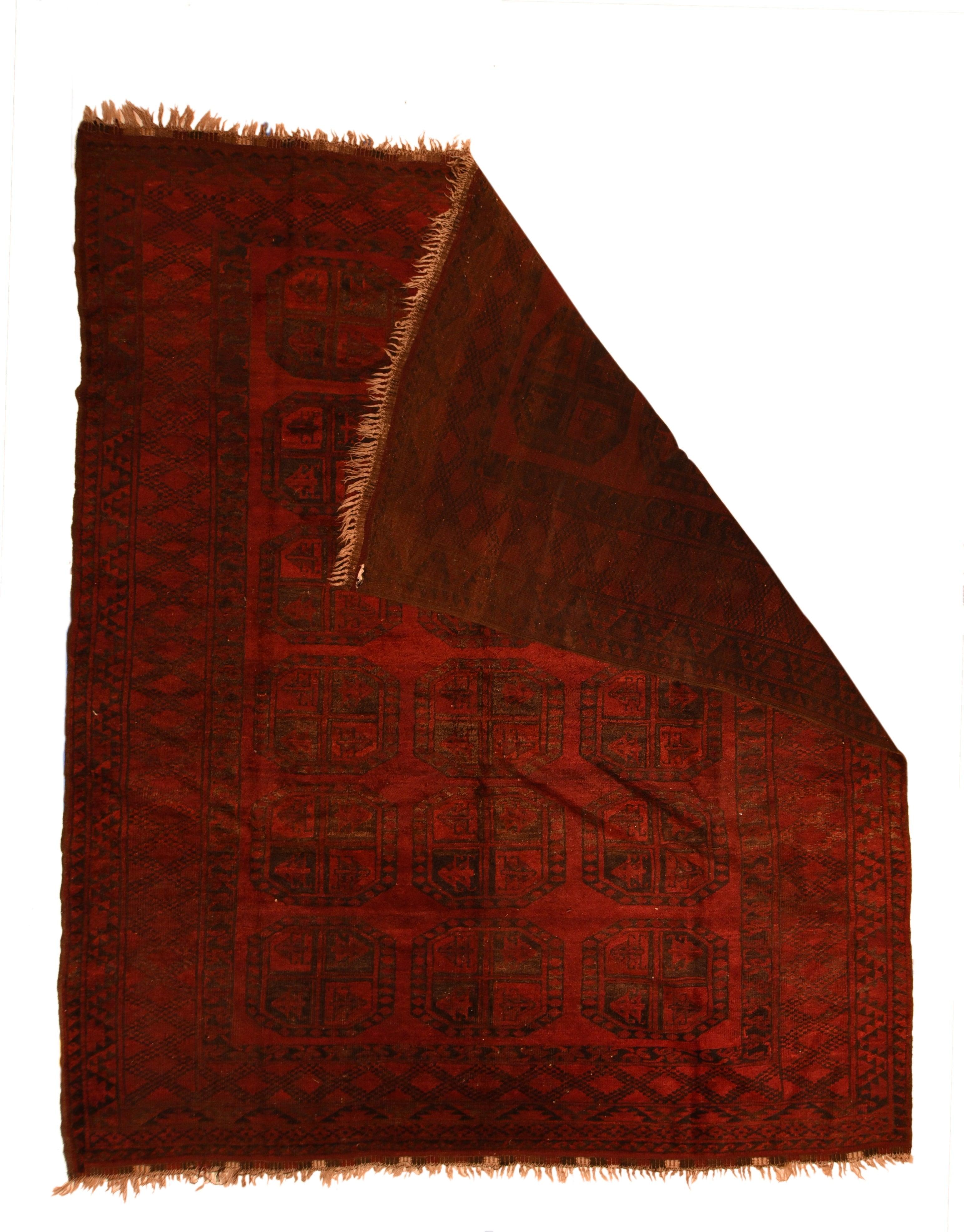 Vintage Afghan Rug 7'4'' x 8'4''. The rich red field presents three columns each of six characteristic Quartered guls, with no minors between, framed by a main border of open, chained lozenges, and geometric minors. Thick pile, medium-coarse weave