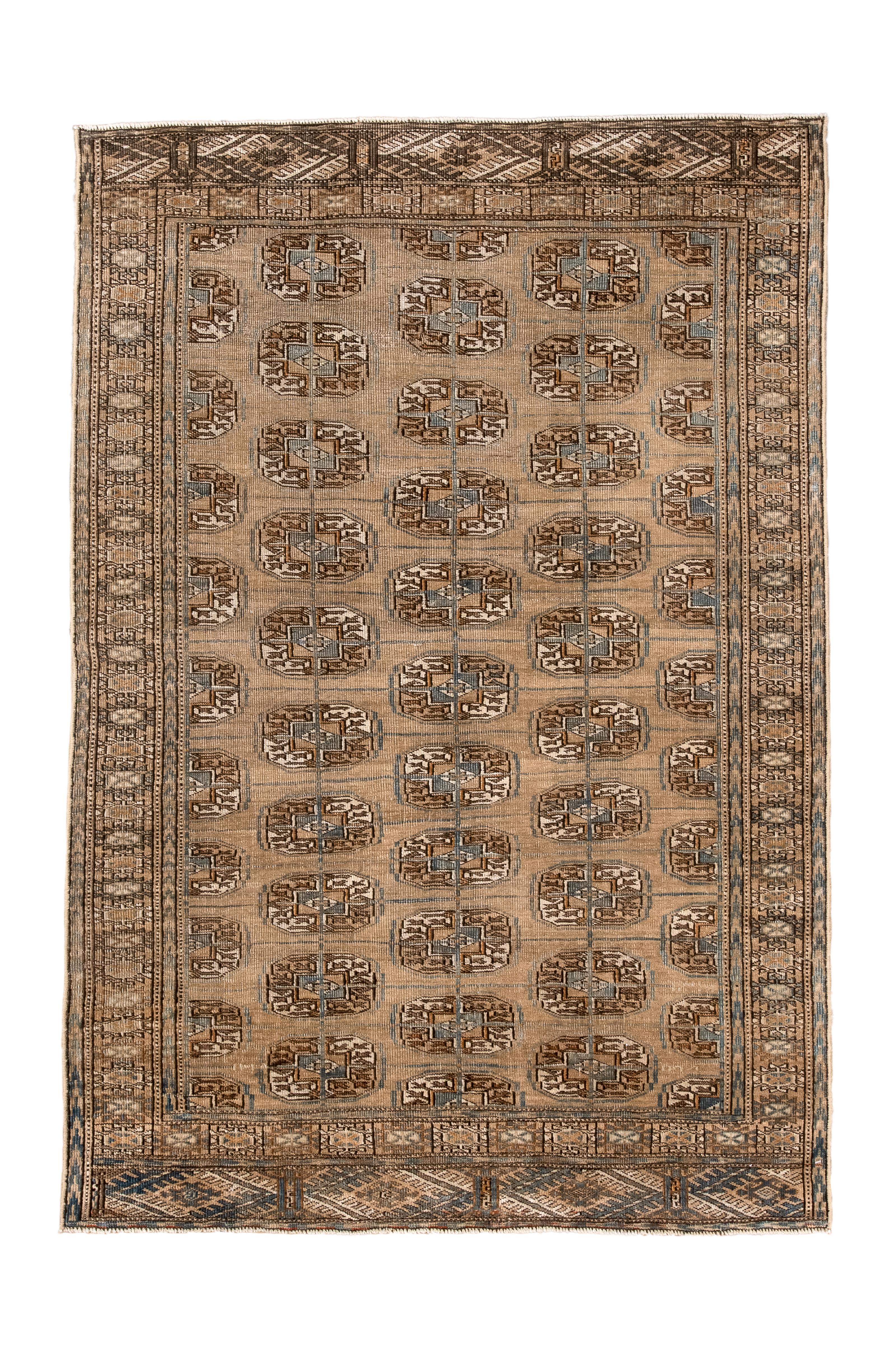 Probably Tekke tribe, this nomadic scatter shows a medium brown field with offset columns of elliptical quartered Tekke emblematic guls, with no minor guls. Border with stellate octagons and matching elems (extra end panels) with flattened, rayed