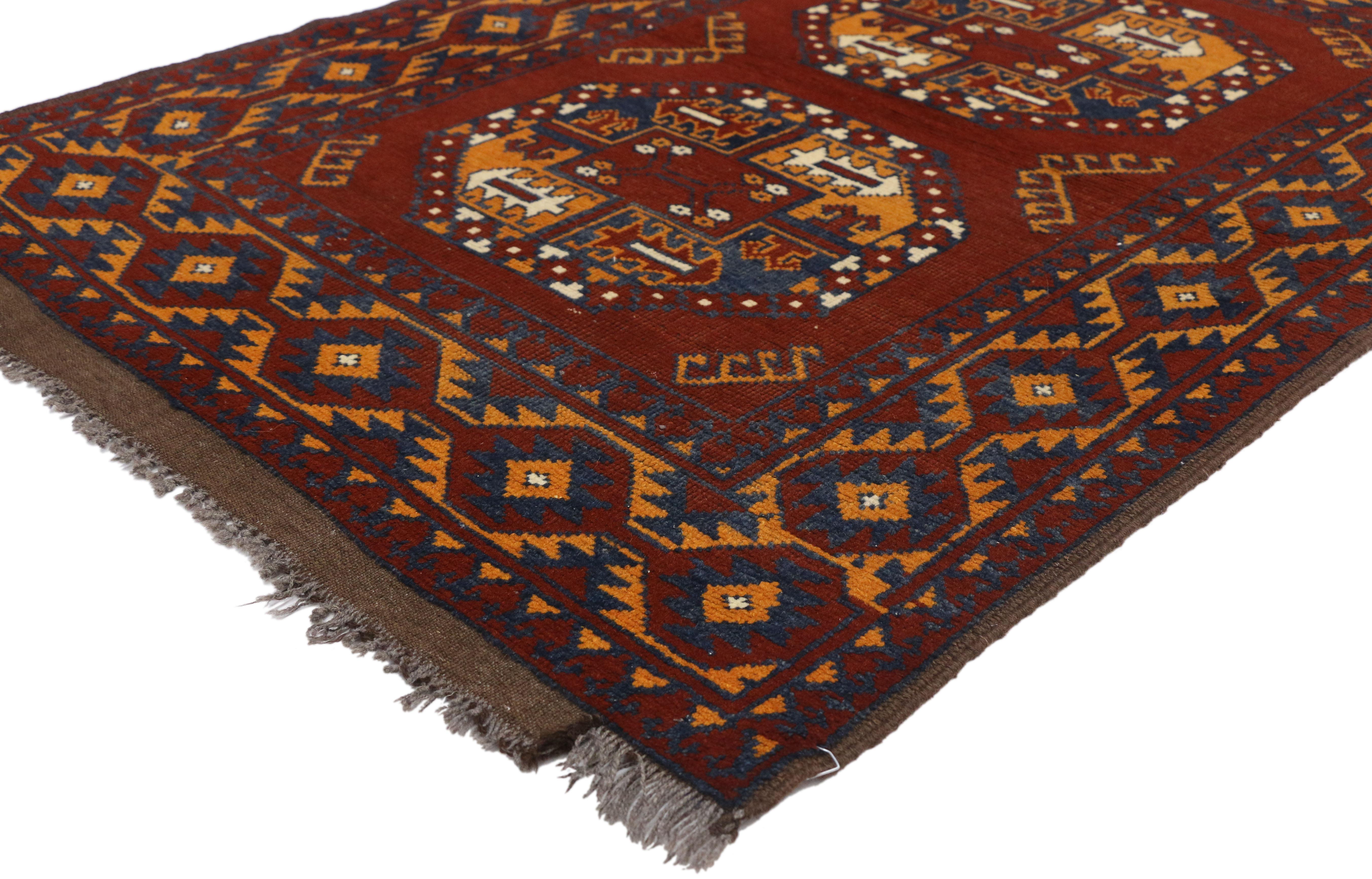 74664 vintage Afghan rug with Mid-Century Modern Vibes and Tribal style. Add a Mid-Century Modern vibe with this hand knotted wool vintage Afghan rug with tribal style. It features two octagonal gul medallions with geometric motifs. It is enclosed