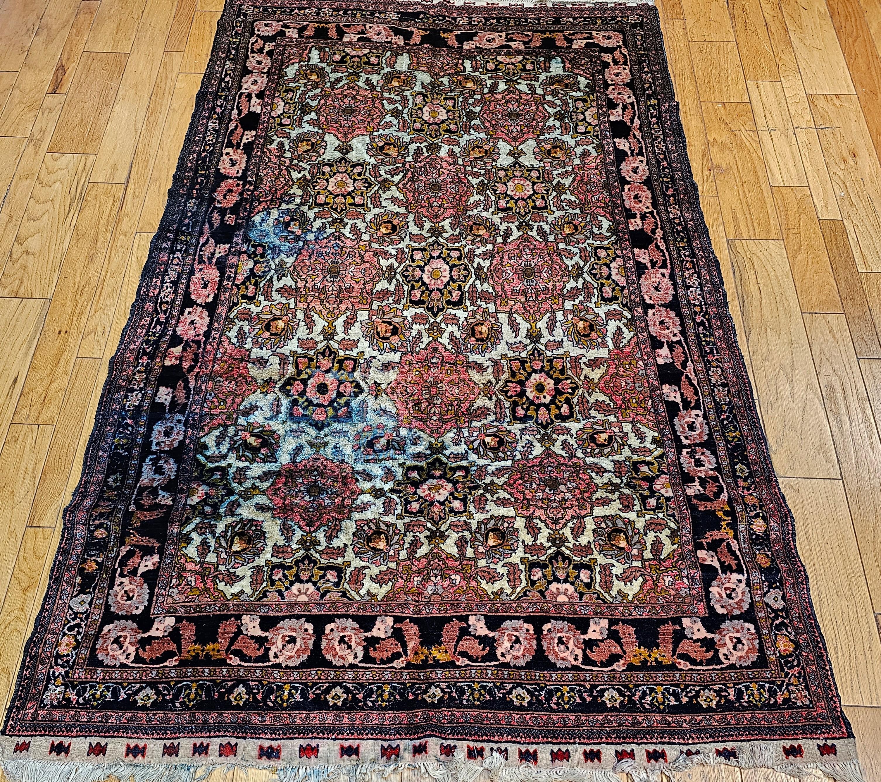 Enhance your living space with this remarkable vintage silk rug from Herat, Afghanistan, dating back to the early 1900s. Hand-knotted with meticulous craftsmanship, this room-sized rug features a captivating all-over geometric pattern highlighted by