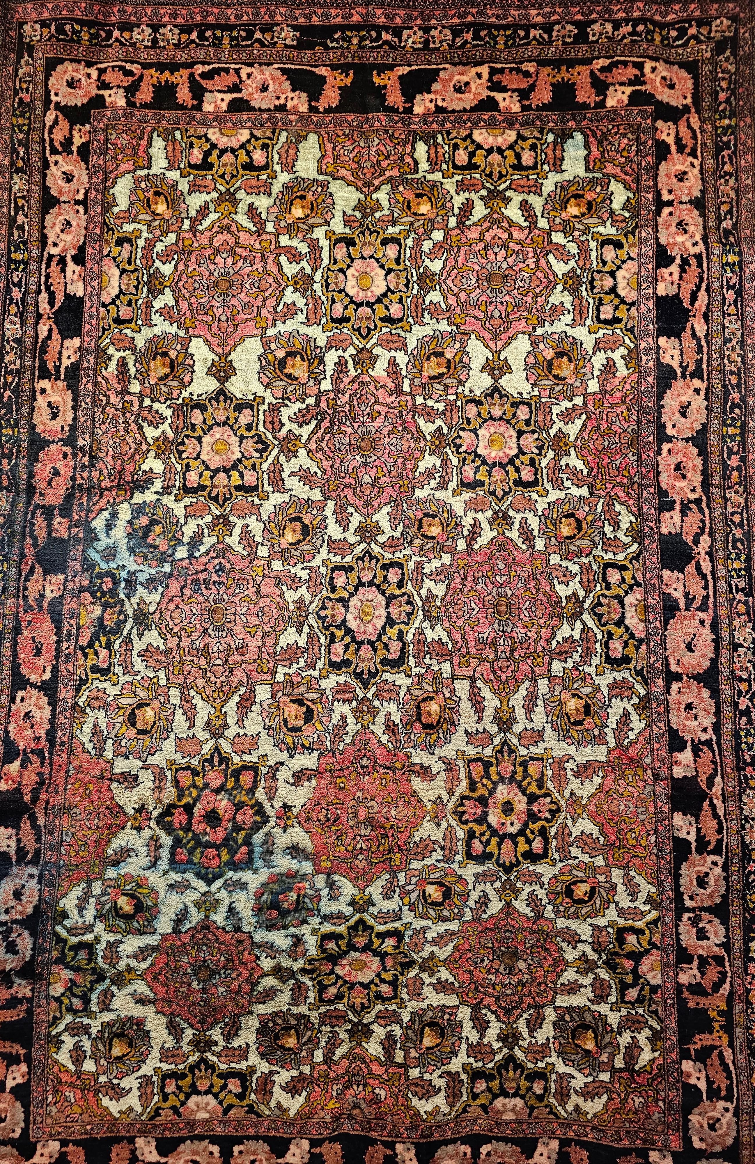 Vintage room-size hand-knotted silk rug from Herat, Afghanistan circa the mid 1900s.  The rug is in an allover pattern consisting of large medallions in red, brown, and black colors.  The medallions show beautifully on a cream-colored silk field. 