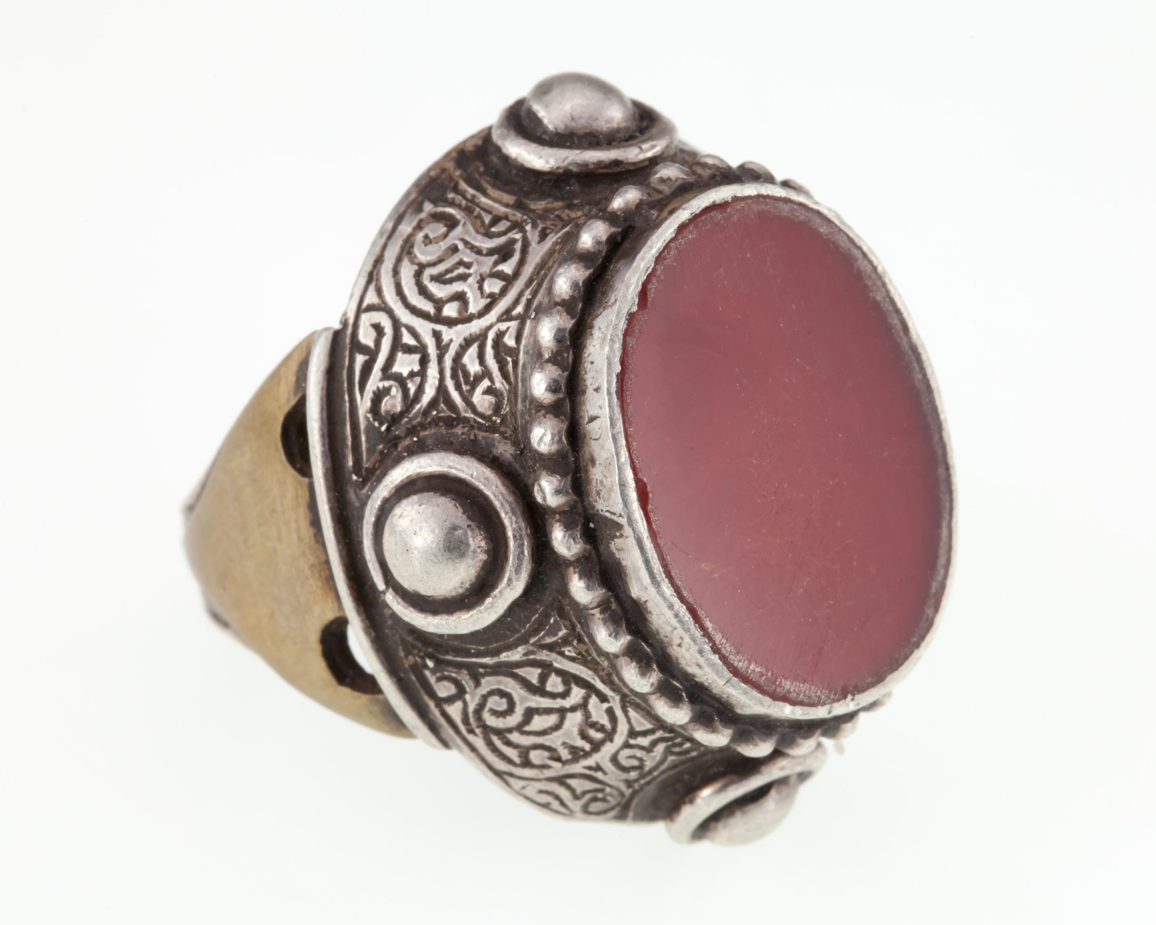 Gorgeous Silver and Brass Afghan Ring
Features Flat Carved Carnelian Stone
Nice Stud and Etched Detailing with Antiqued Accents
Dimensions of Stone = 20 mm x 15 mm
Dimensions of Plaque = 32 mm x 27 mm
Total Mass = 27.4 grams
Gorgeous Ring!