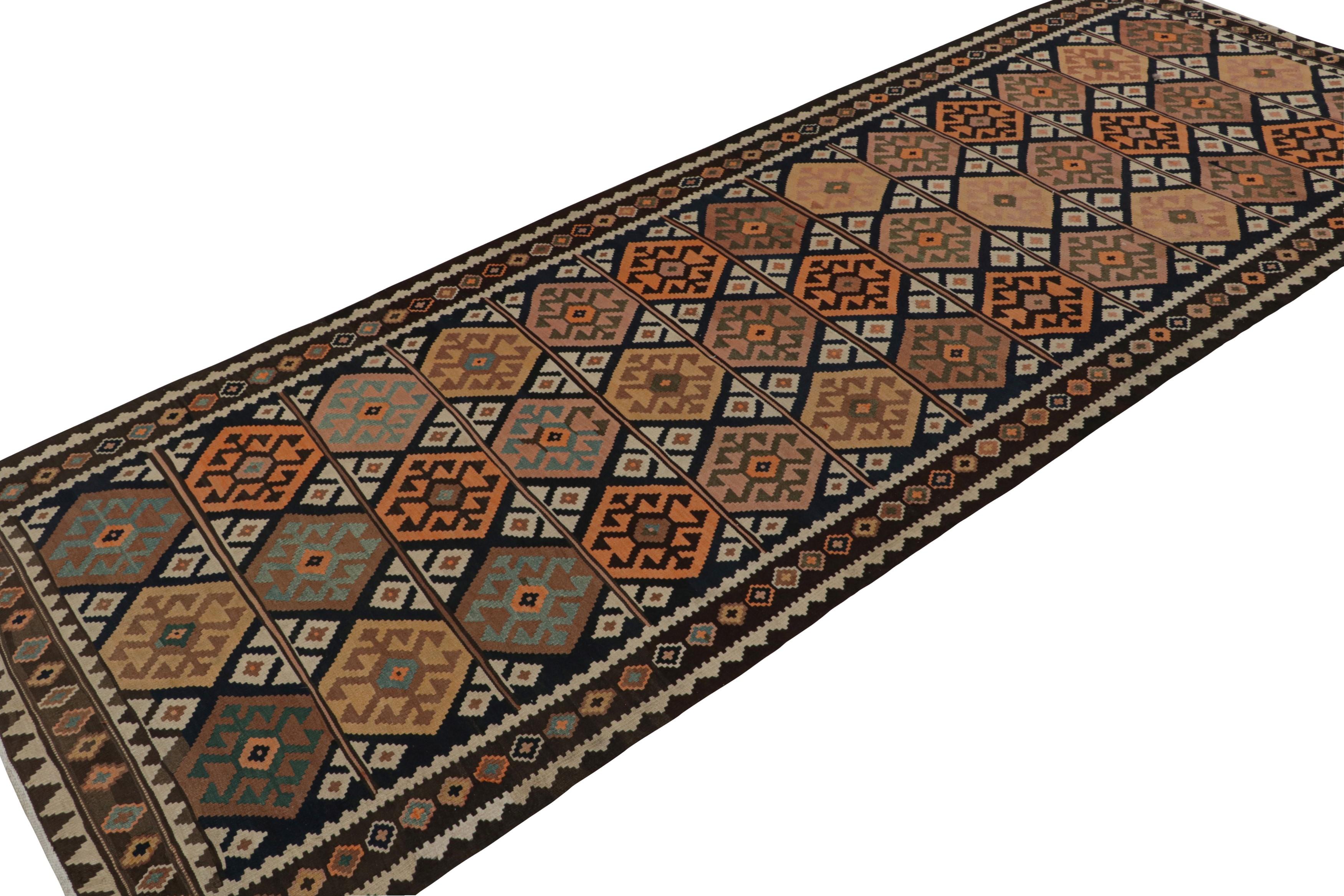 Hand-knotted in wool, circa 1960-1970, from the titular region of Turkey, this 5x14 vintage Afghan tribal kilim and gallery runner rug is an exciting addition to the Rug & Kilim Collection. This rug features a colorful play of medallion-style