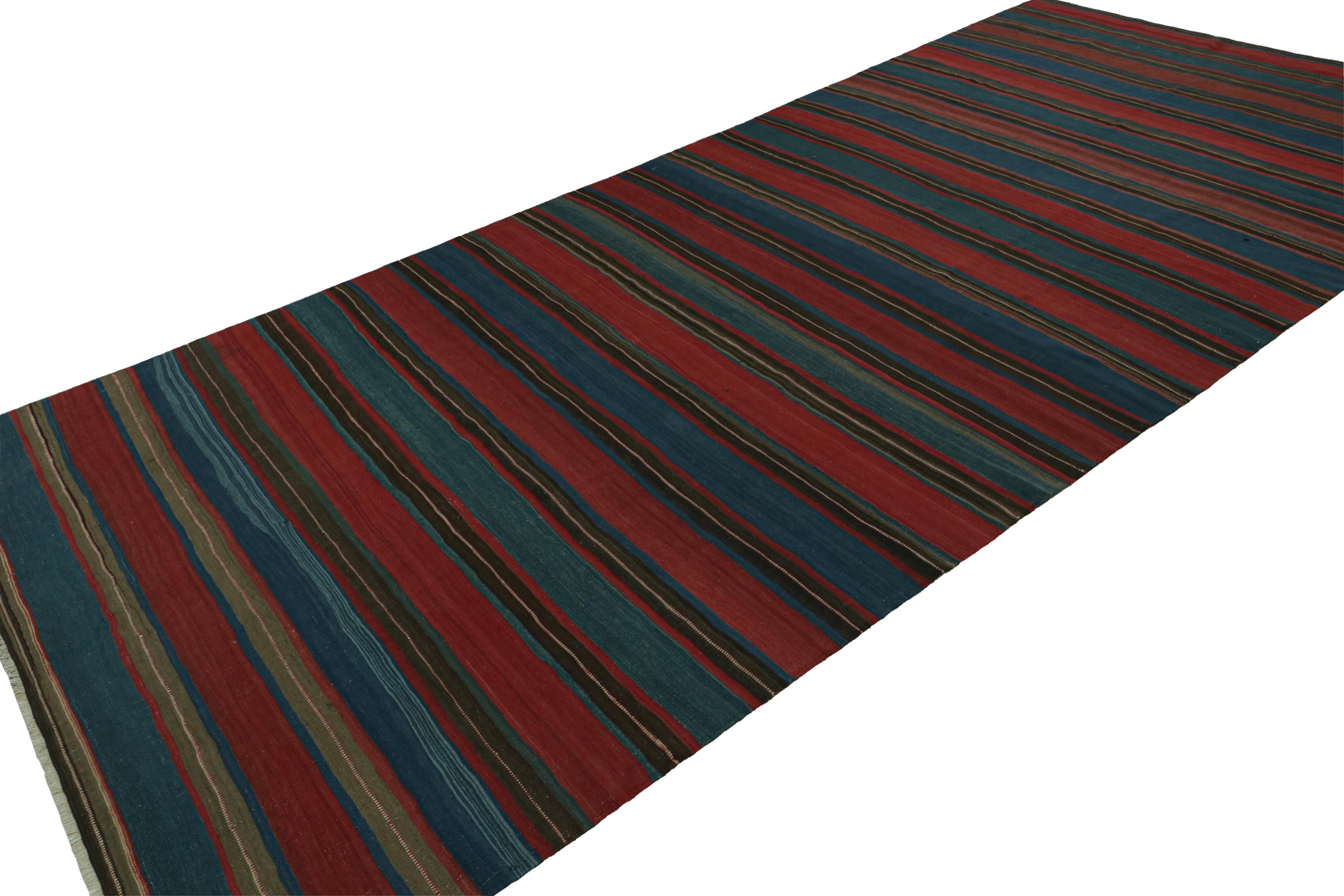 Handwoven in wool, circa 1950-1960, this 7x15 vintage Afghan tribal kilim, features fencepost geometric striped patterns in red and blue, across the entire field. 

On the design: 

As an exciting new curation in Rug & Kilim Collection, this rug 