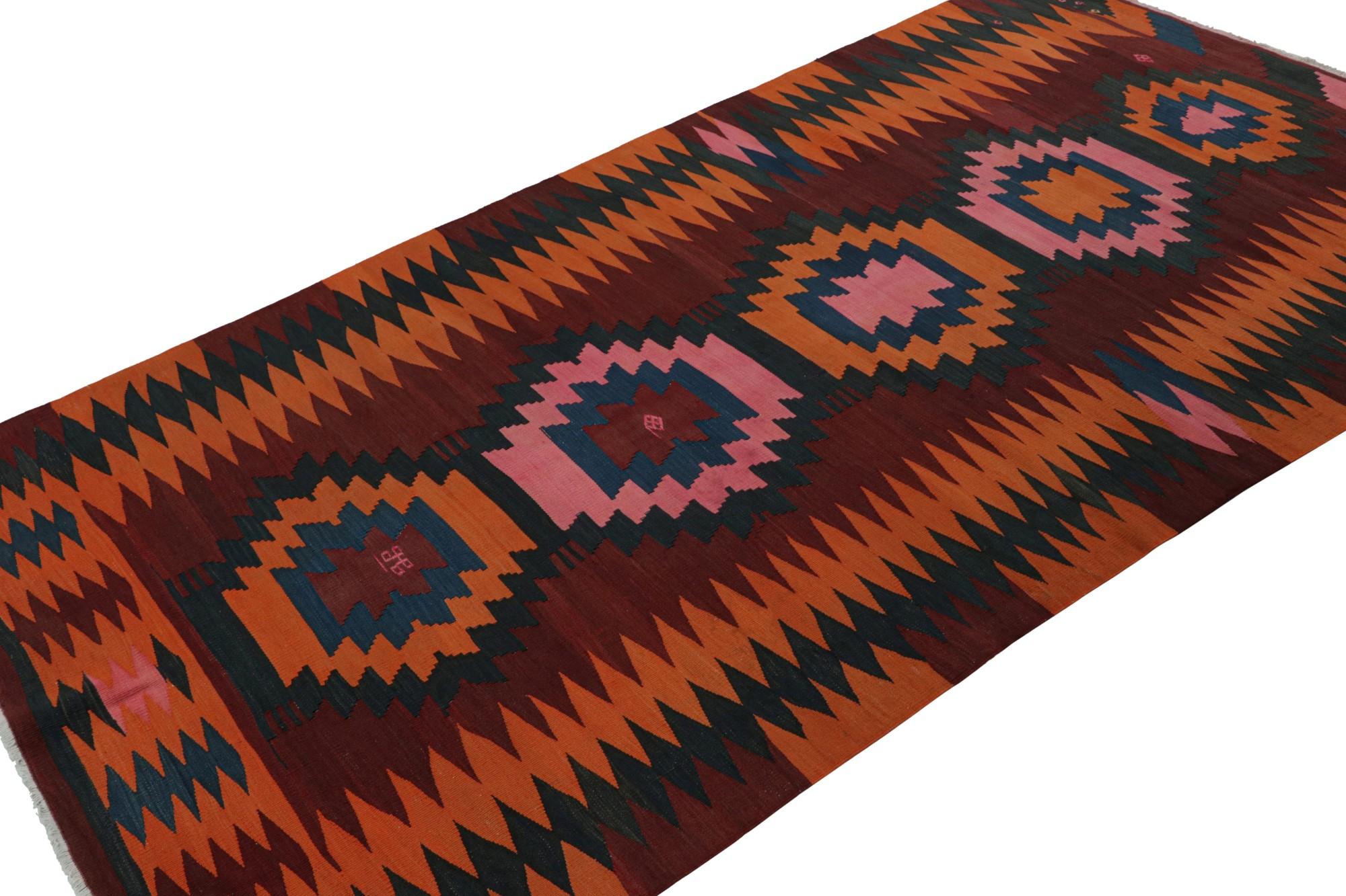 Hand knotted in wool, this 4x9 vintage Afghan tribal kilim rug is an extraordinarily simple piece in red with orange, blue and pink geometric patterns and a simple presence. 

On the Design: 

The minimalist design prefers geometric patterns in rich