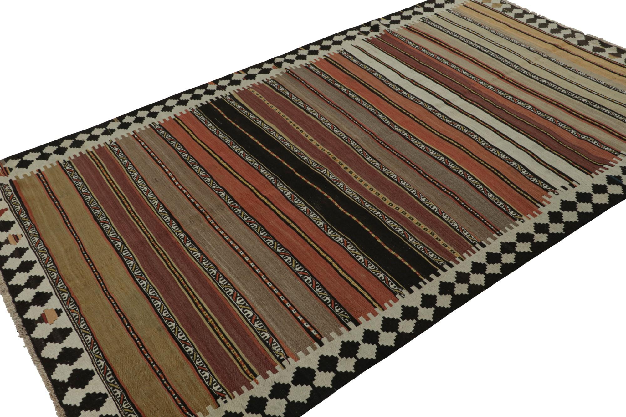Hand knotted in wool, this 5x9 vintage Afghan tribal kilim rug is an extraordinarily simple piece with beige/brown, silver/gray, black and pink geometric stripes and a simple presence. 

On the design: 

The design enjoys warm earthy colors in