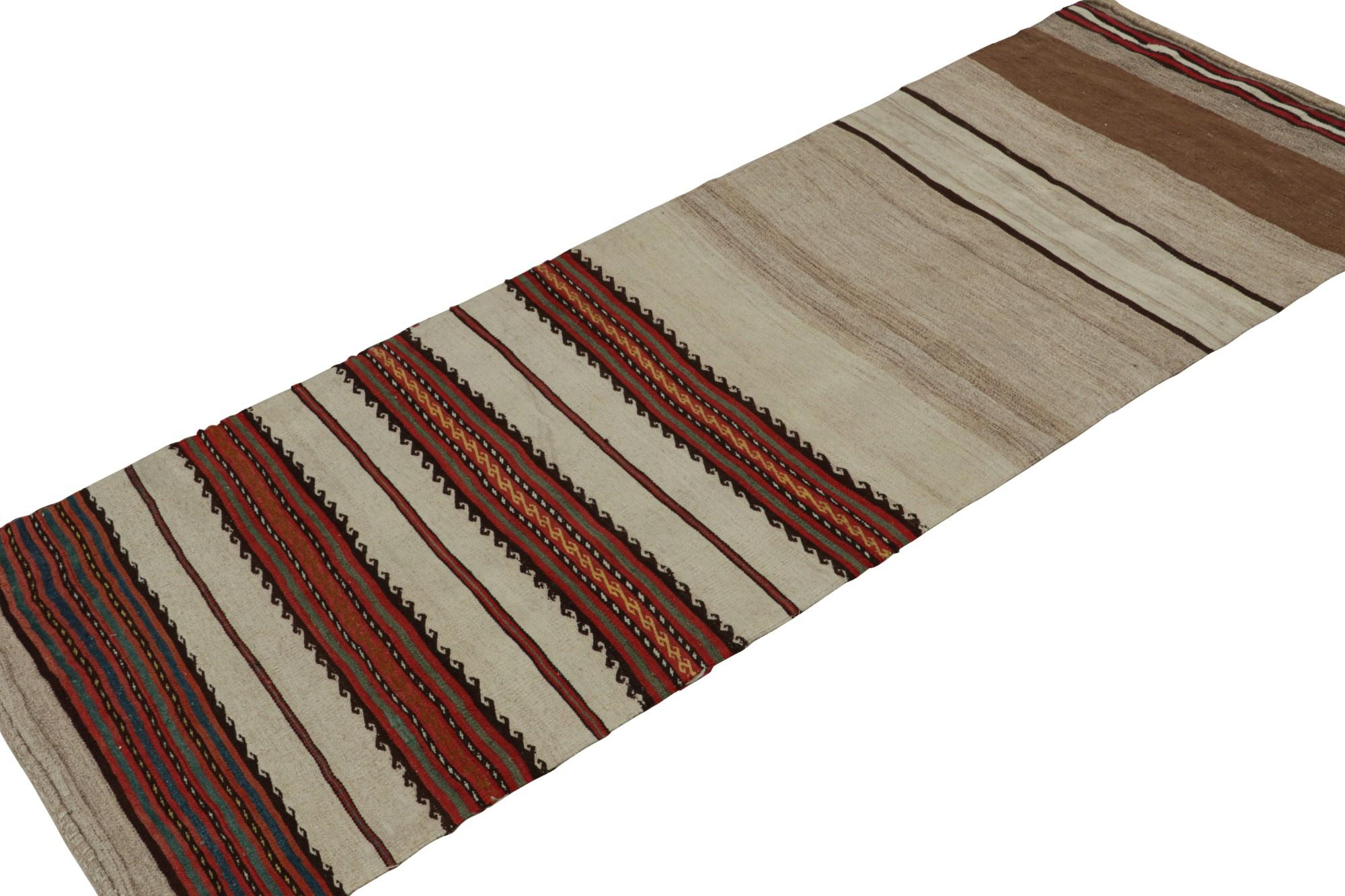 Handwoven in wool, this 2x7 vintage Afghan tribal kilim runner rug is an extraordinarily simple piece in beige with red stripes and a simple presence. 

On the Design: 

The minimalist design prefers geometric stripes in rich beige/brown and red