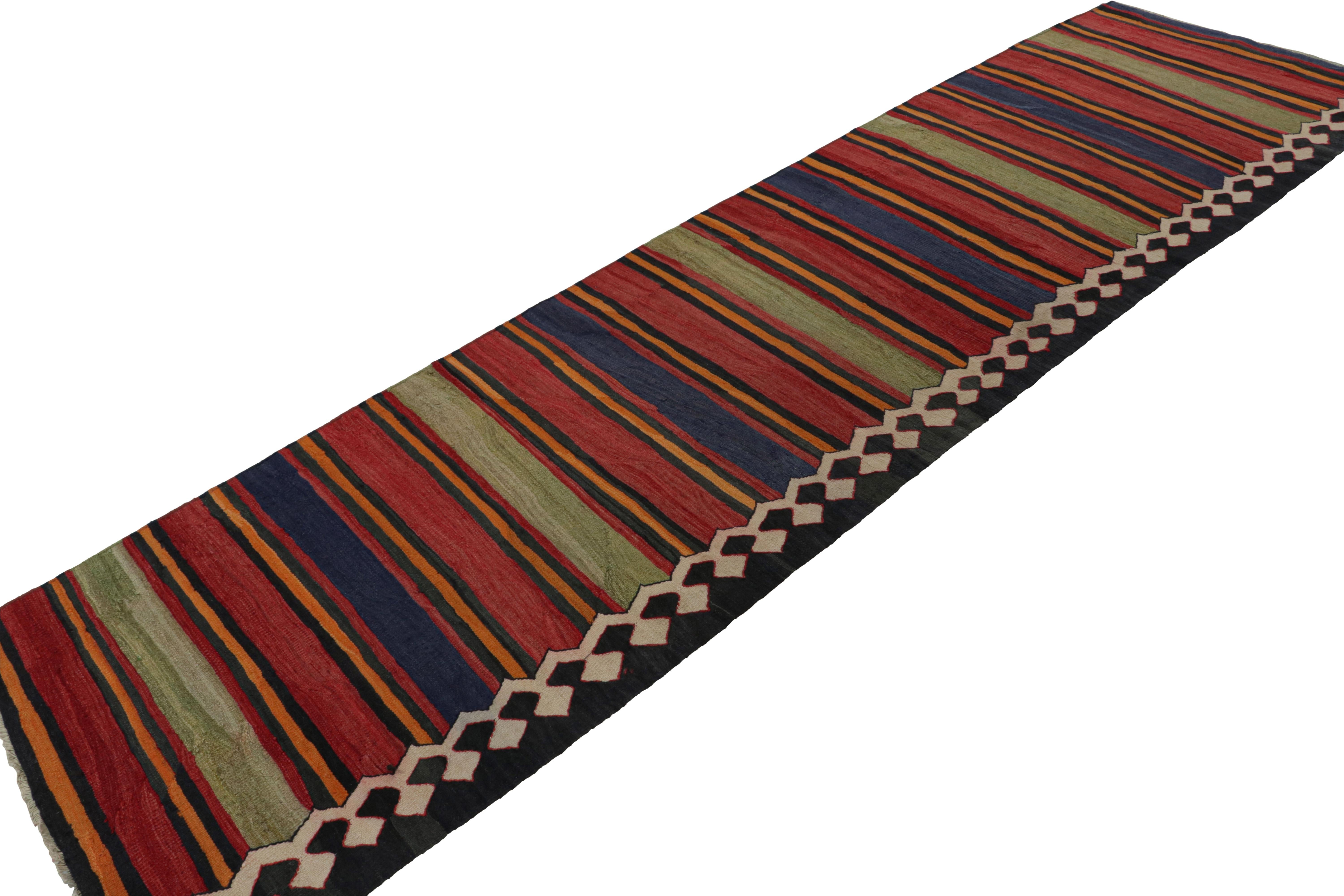 Hand knotted in wool, this 3x12 vintage  Afghan tribal kilim runner rug, originating circa 1950-1960, is an exciting new addition to the Rug & Kilim collection.  

On the Design: 

Originating from Afghanistan, this runner rug is a rich versatile
