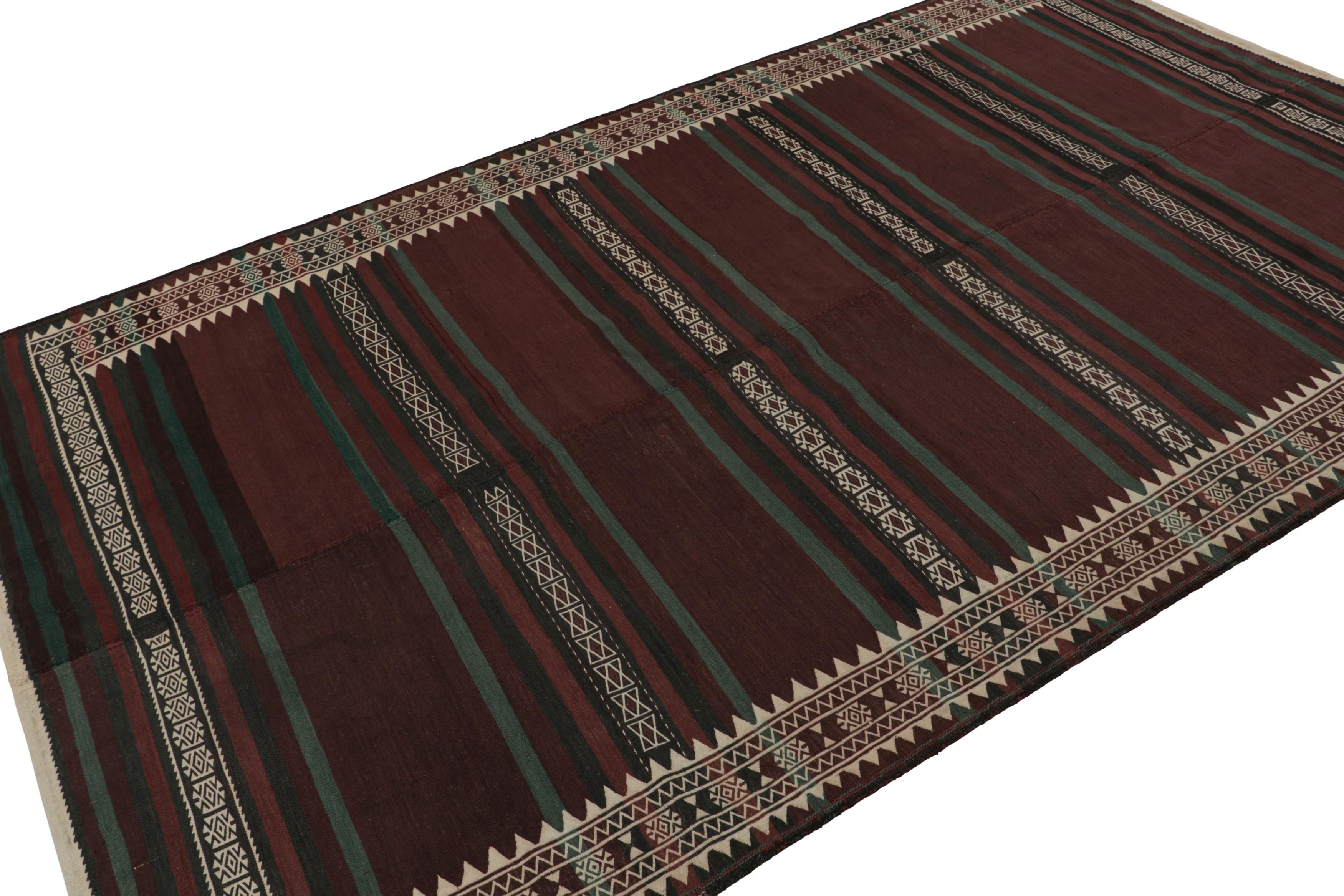 Handwoven in wool circa 1950-1960, this 6x9 vintage Afghan kilim is a new curation from Rug & Kilim’s collection. 

On the Design:

This particular rare piece enjoys brown, black & green stripes with fine white detailing. The constitution embraces a
