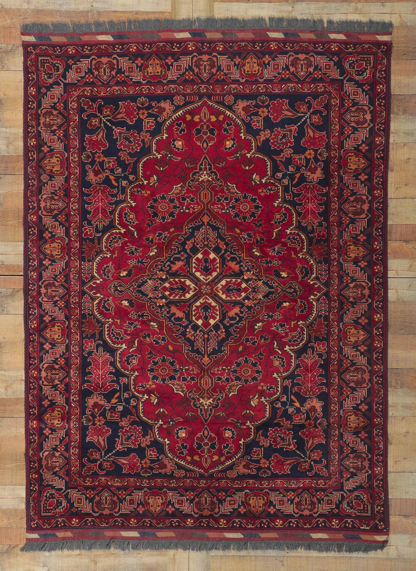 78344 Vintage Afghani Rug, 05'10 x 08'00.
Featuring a timeless elegance and regal charm, this exquisite hand-knotted wool vintage Afghani rug showcases a lozenge medallion, gracefully anchored with a trefoil pendant on either side. The captivating