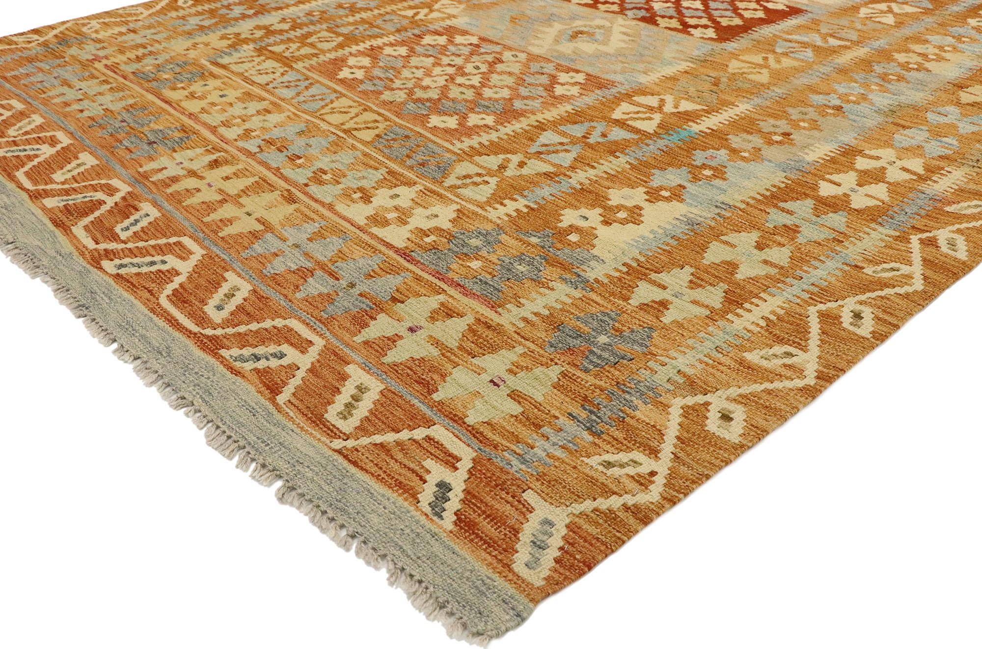 80128 vintage Afghani Kilim rug, 05'08 x 08'02. Full of tiny details and nomadic charm, this handwoven wool vintage Afghan kilim rug is a captivating vision of woven beauty. The eye-catching tribal design and vibrant earth-tone colors woven into