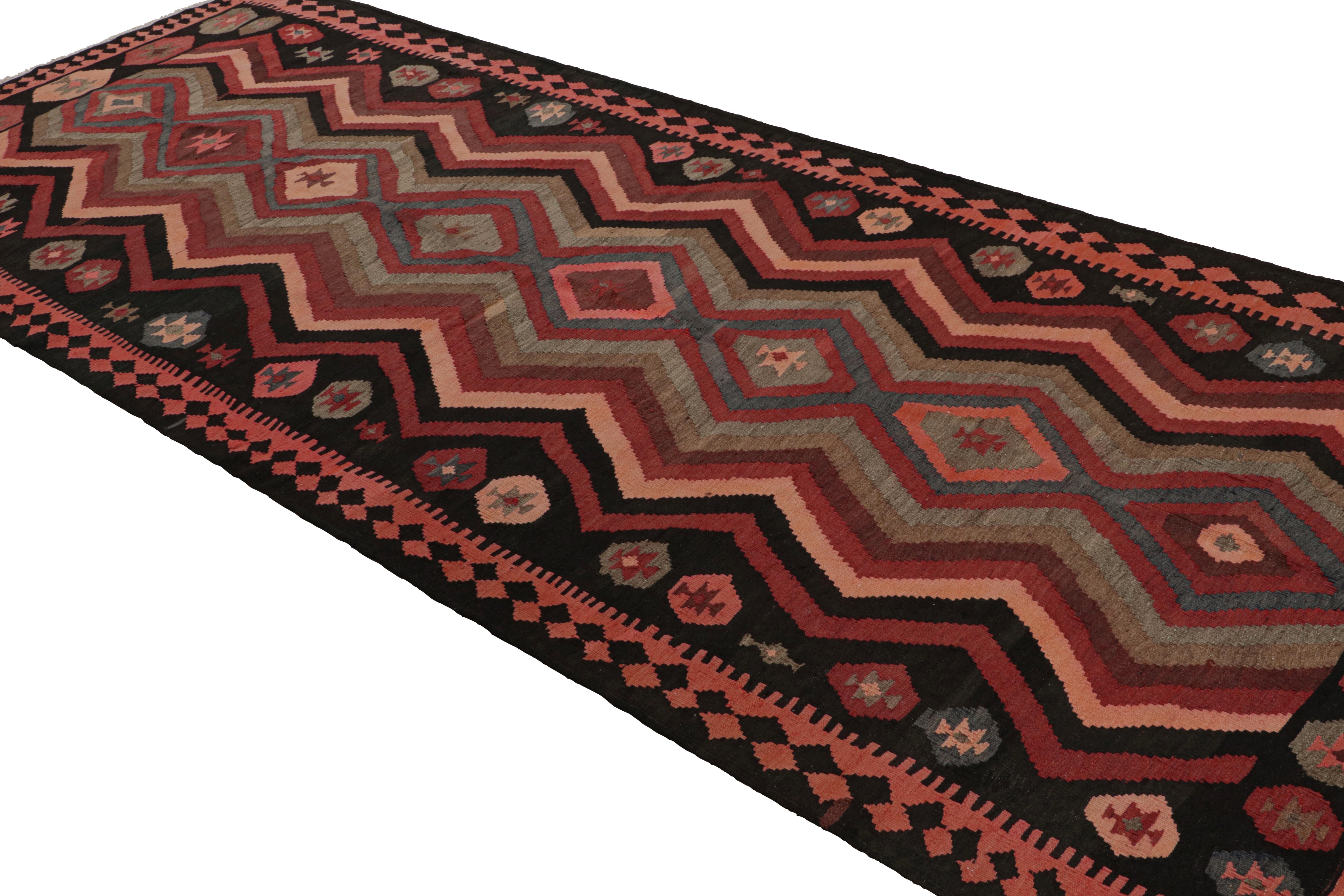 Handwoven in wool, circa 1950-1960, this 5x12 vintage Afghani tribal kilim rug, from Afghanistan, features repetitive geometric patterns like chevrons, motifs and fencepost patterns, making it a rich and unusual piece. 

On the Design: 

Originating