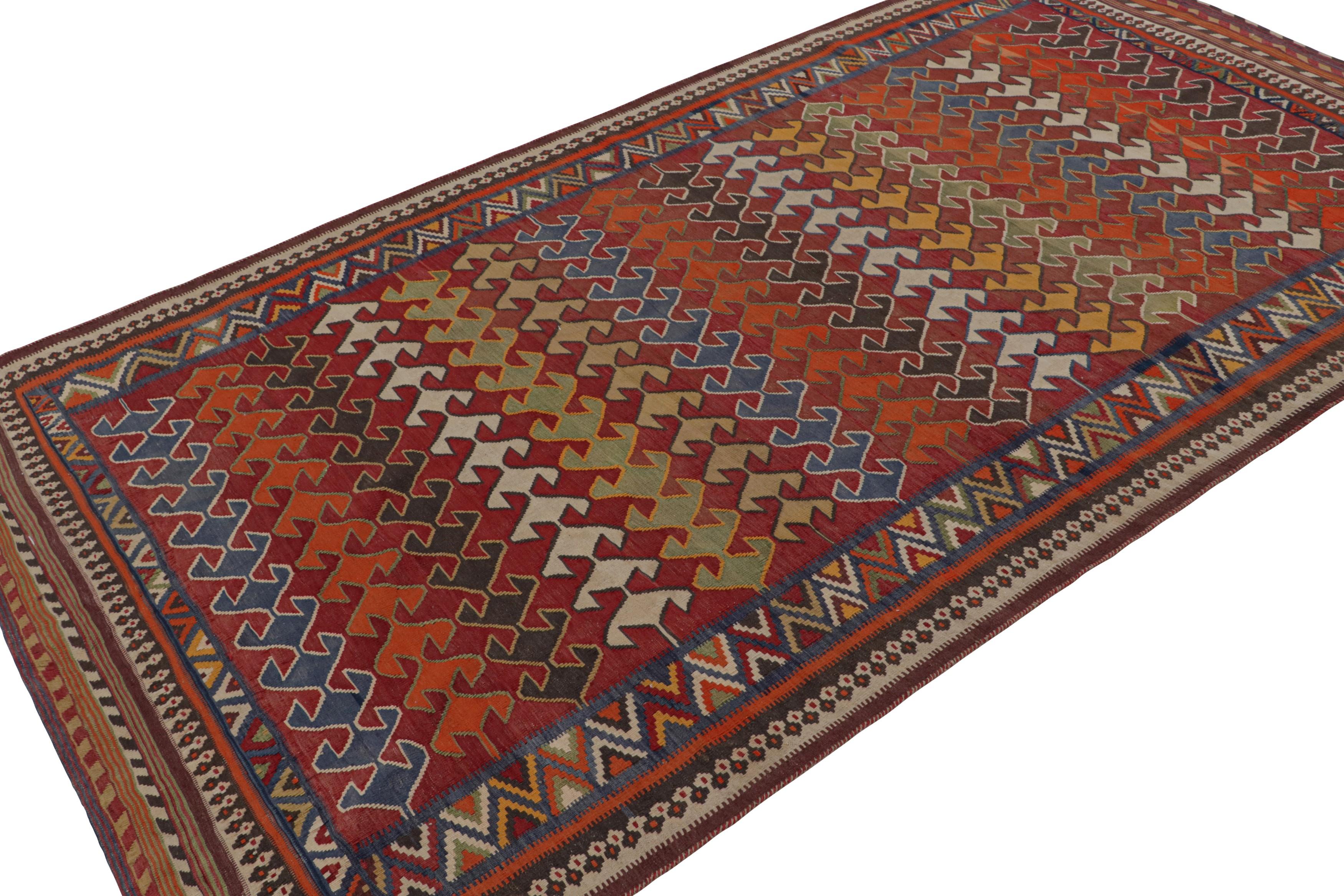 Handwoven in wool, circa 1950-1960, this 5x9 Afghani tribal Kilim rug, featuring vibrant colors and geometric patterns over a red field, is an exciting addition to the Rug & Kilim Collection.   

On the Design: 

A special kilim rug in the Rug &
