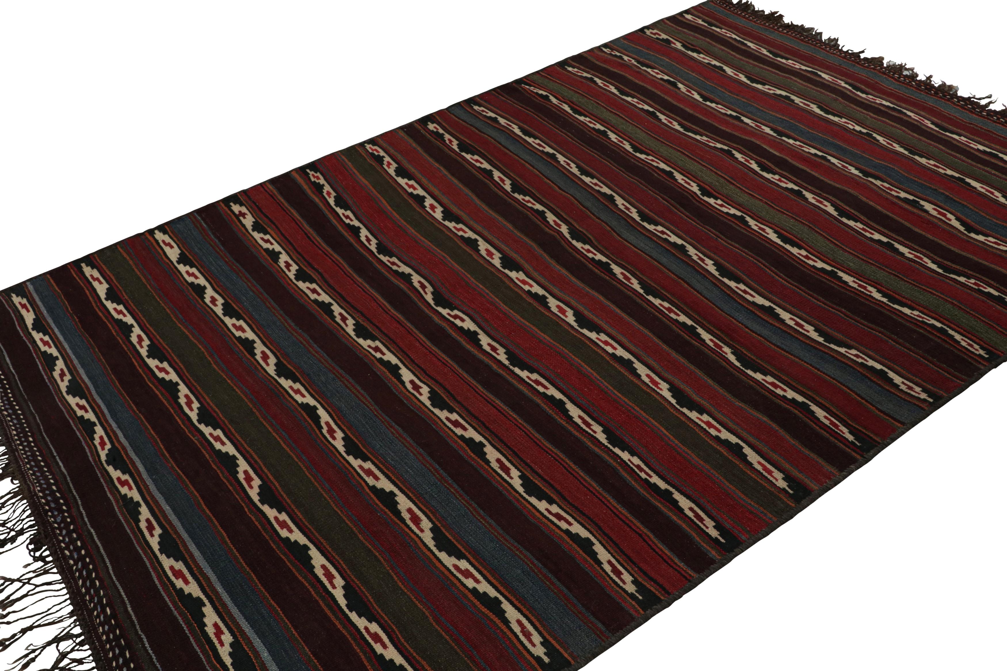 Handwoven in wool, circa 1950-1960, this 6x9 vintage Afghan tribal kilim rug, with red and blue stripes and teal notes, featuring off-white geometric patterns is a simple yet a very personal piece. 

On the Design: 

Featuring repetitive horizontal