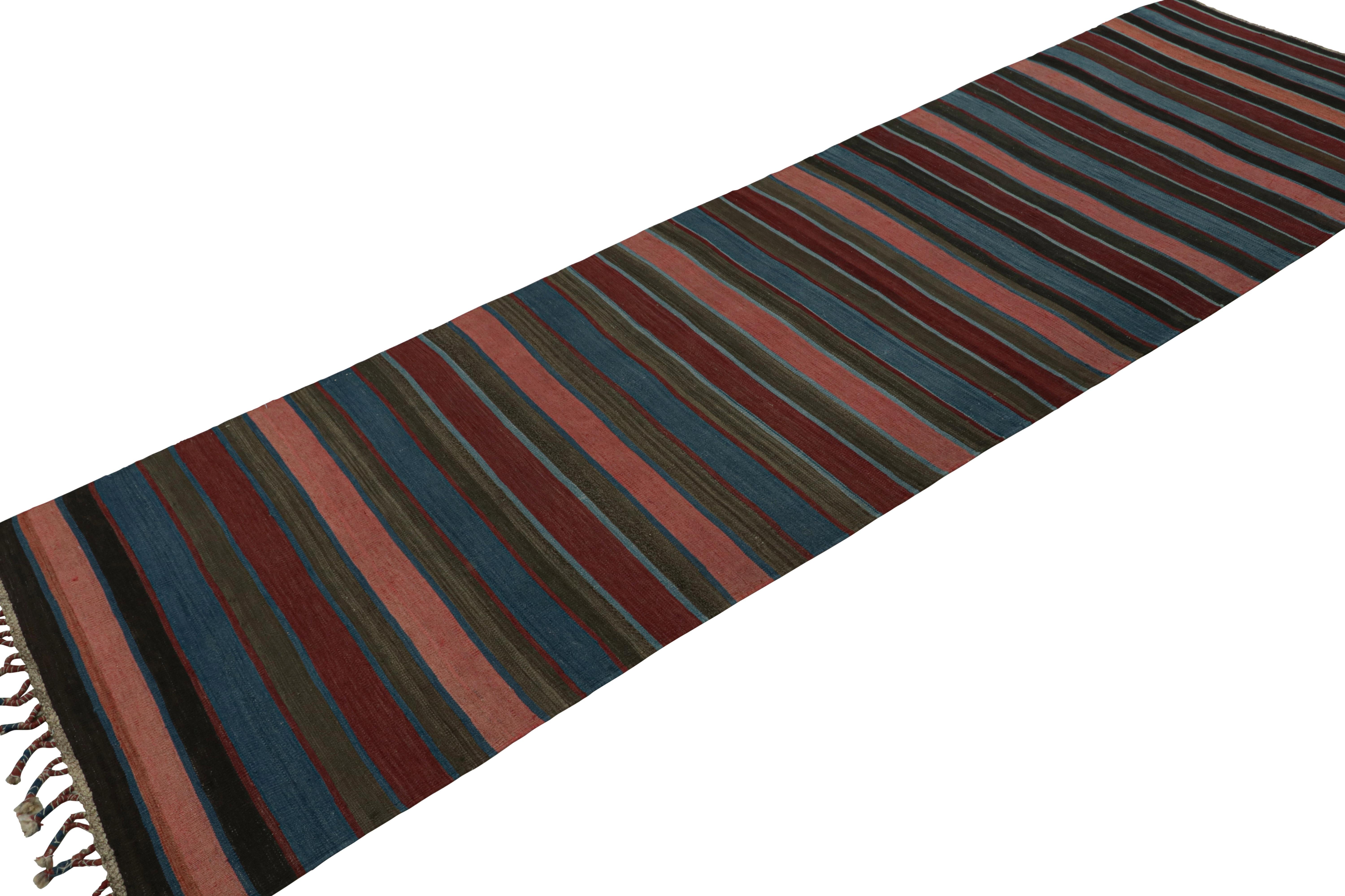 Handwoven in wool, circa 1950-1960, this 3x11 vintage Afghan tribal kilim runner rug, with stripes across its surface, is a classic Afghani design in the Rug & Kilim collection. 

On the design: 

Originating from Afghanistan, this runner rug is a