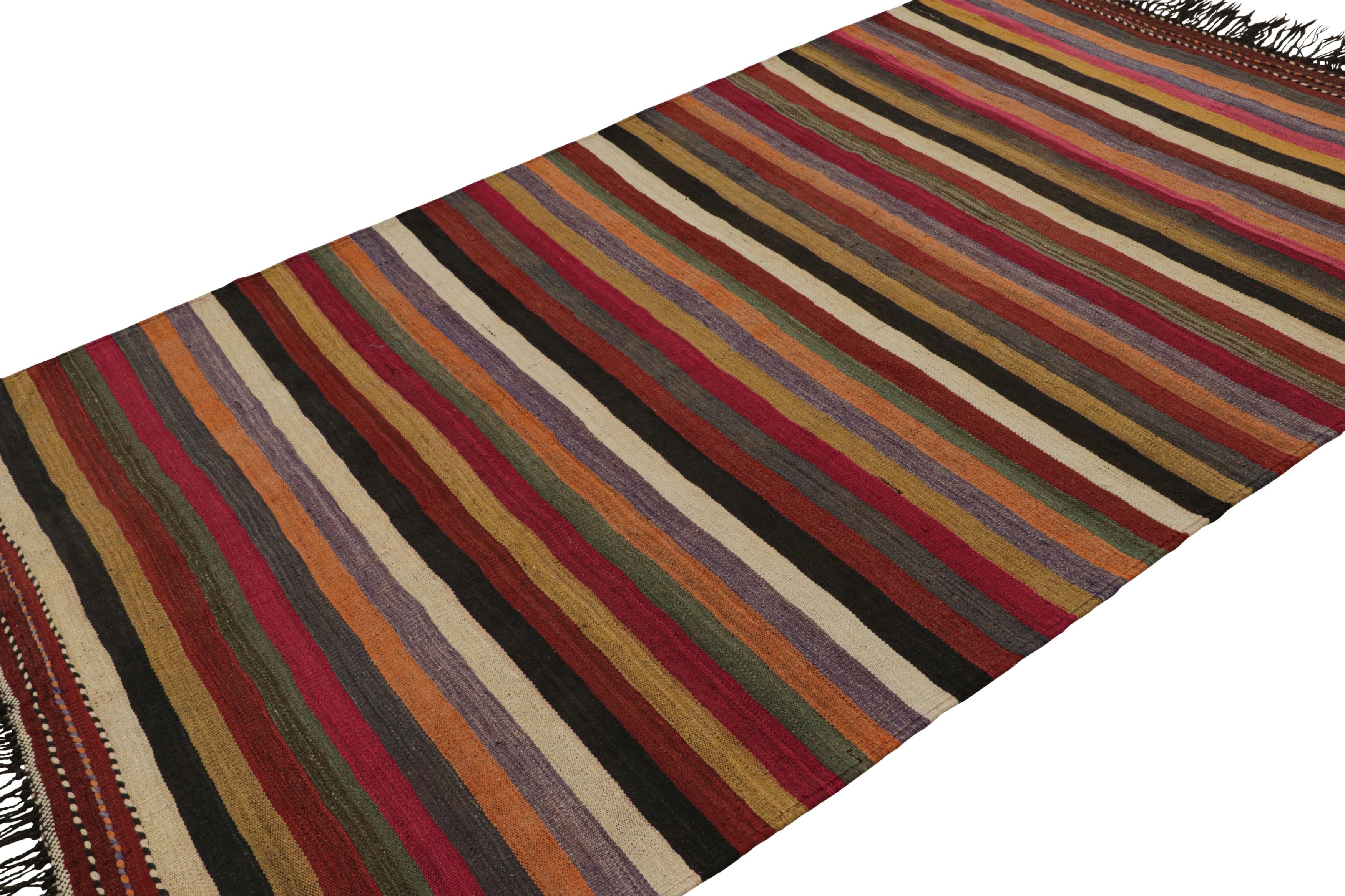 Handwoven in wool, circa 1950-1960, this 6x10 vintage Afghan tribal kilim rug, features a simple repeat pattern with playful color variations of red, green, beige/brown and purple, showcasing a movement and a life in the design. 

On the Design: