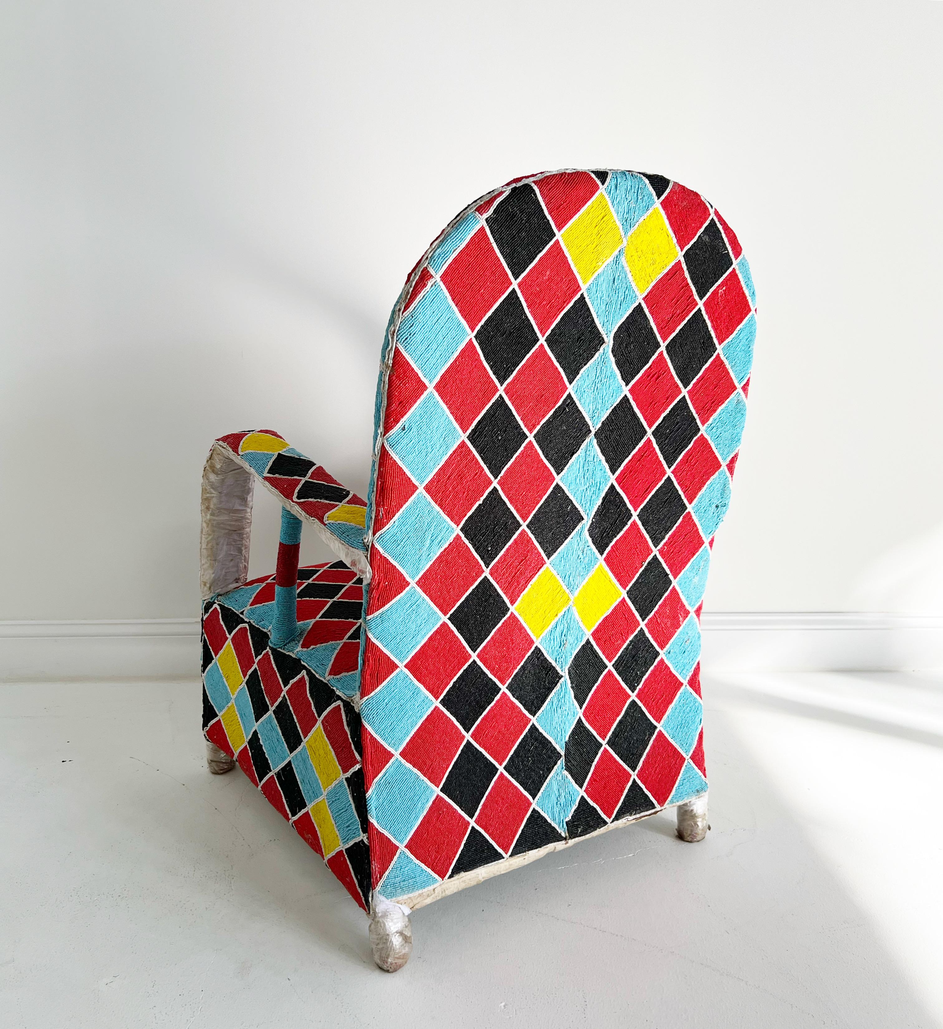 Description
Originally hand-crafted for the Nigerian Yoruba tribe kings and queens, each chair takes approximately 3 months to make. Thousands of tiny glass beads are intricately applied to canvas fabric in beautiful shapes and designs. The fabric