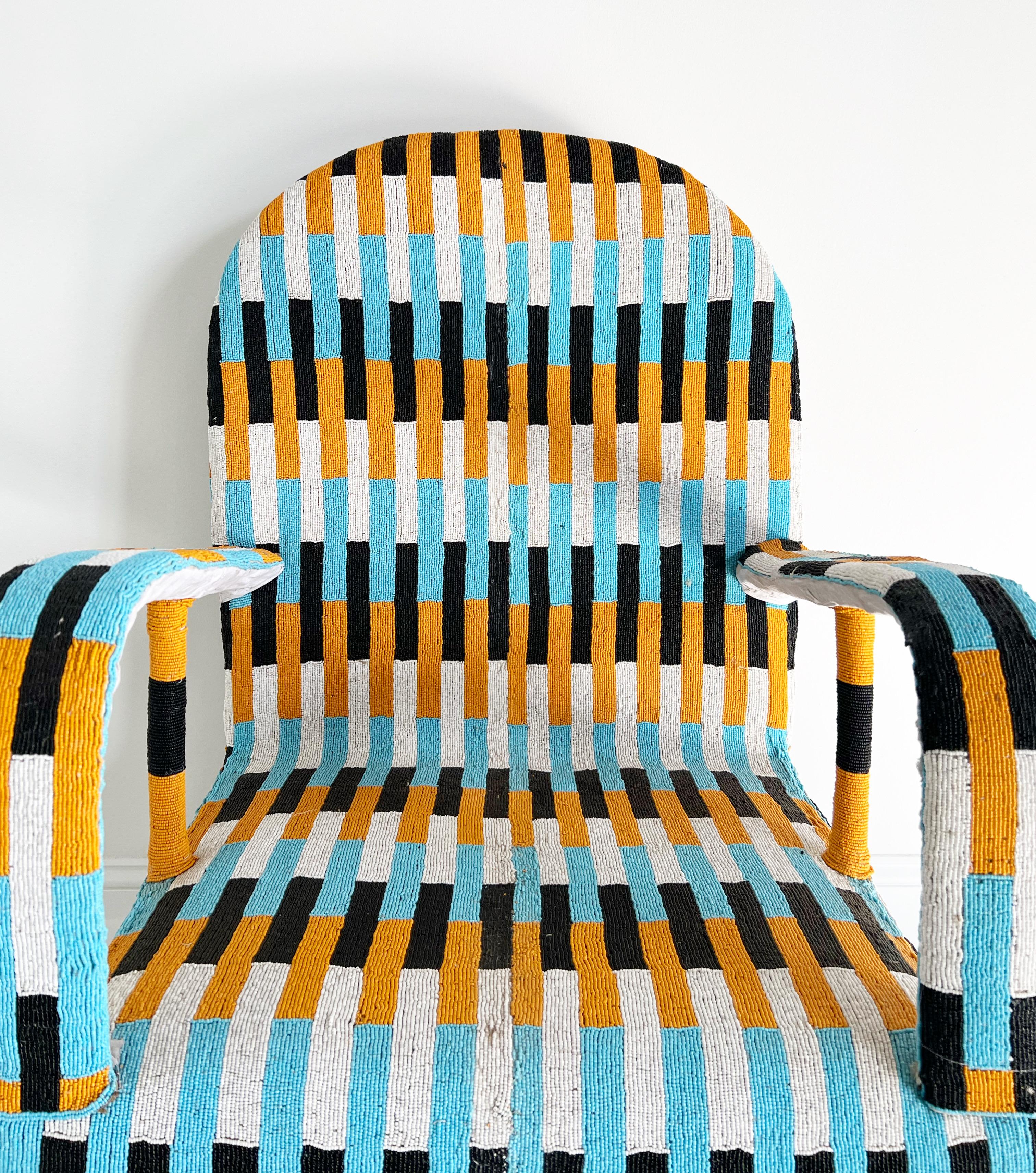 Description
Originally hand-crafted for the Nigerian Yoruba tribe kings and queens, each chair takes approximately 3 months to make. Thousands of tiny glass beads are intricately applied to canvas fabric in beautiful shapes and designs. The fabric