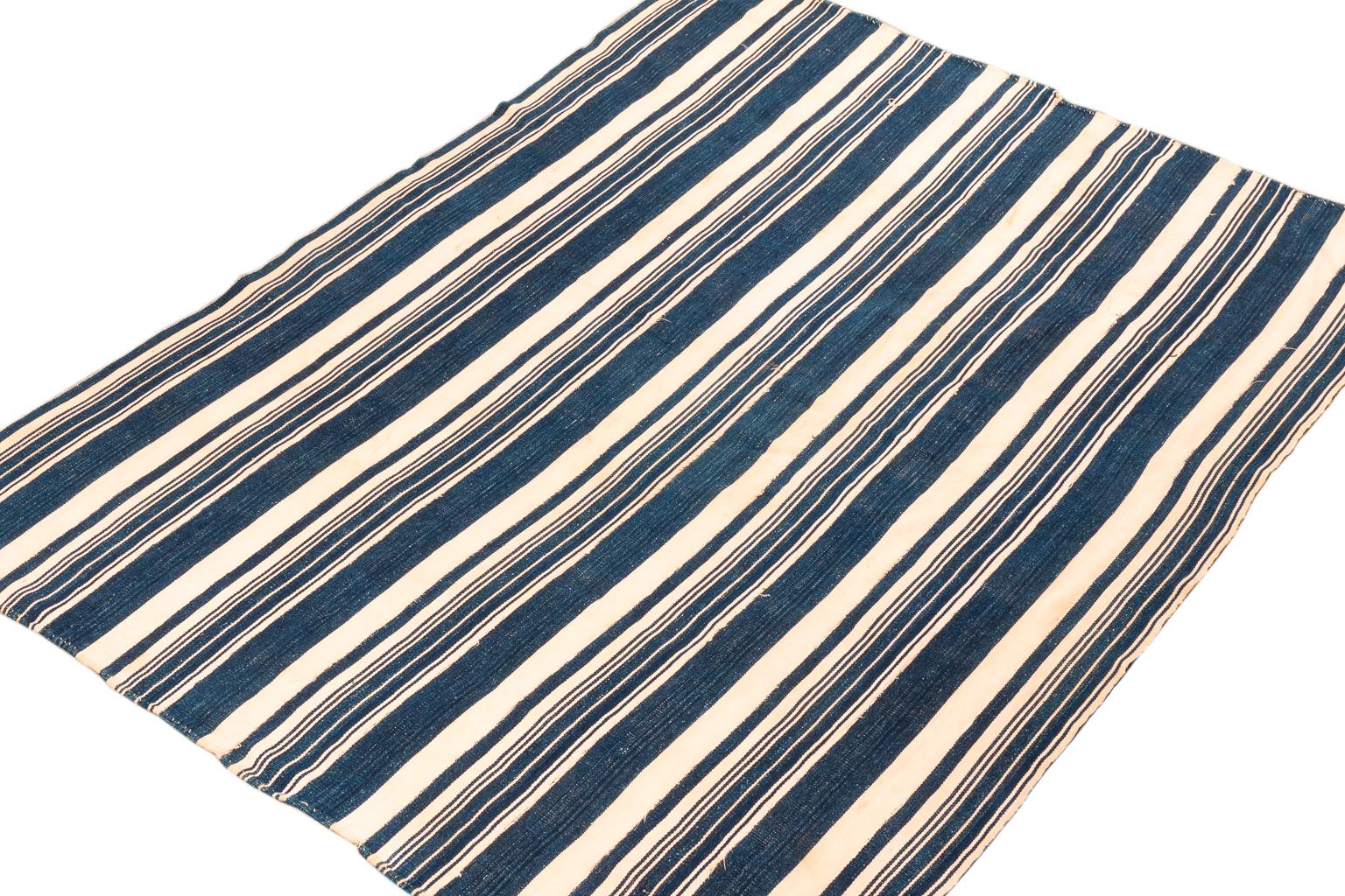 There is nothing like real indigo derived naturally from the Indigo fera species of plant. The color is mesmerizing because of its richness. Hand dyed on hand-spun cotton this blue and white stripe wrap is a great example of these tribal weavings.