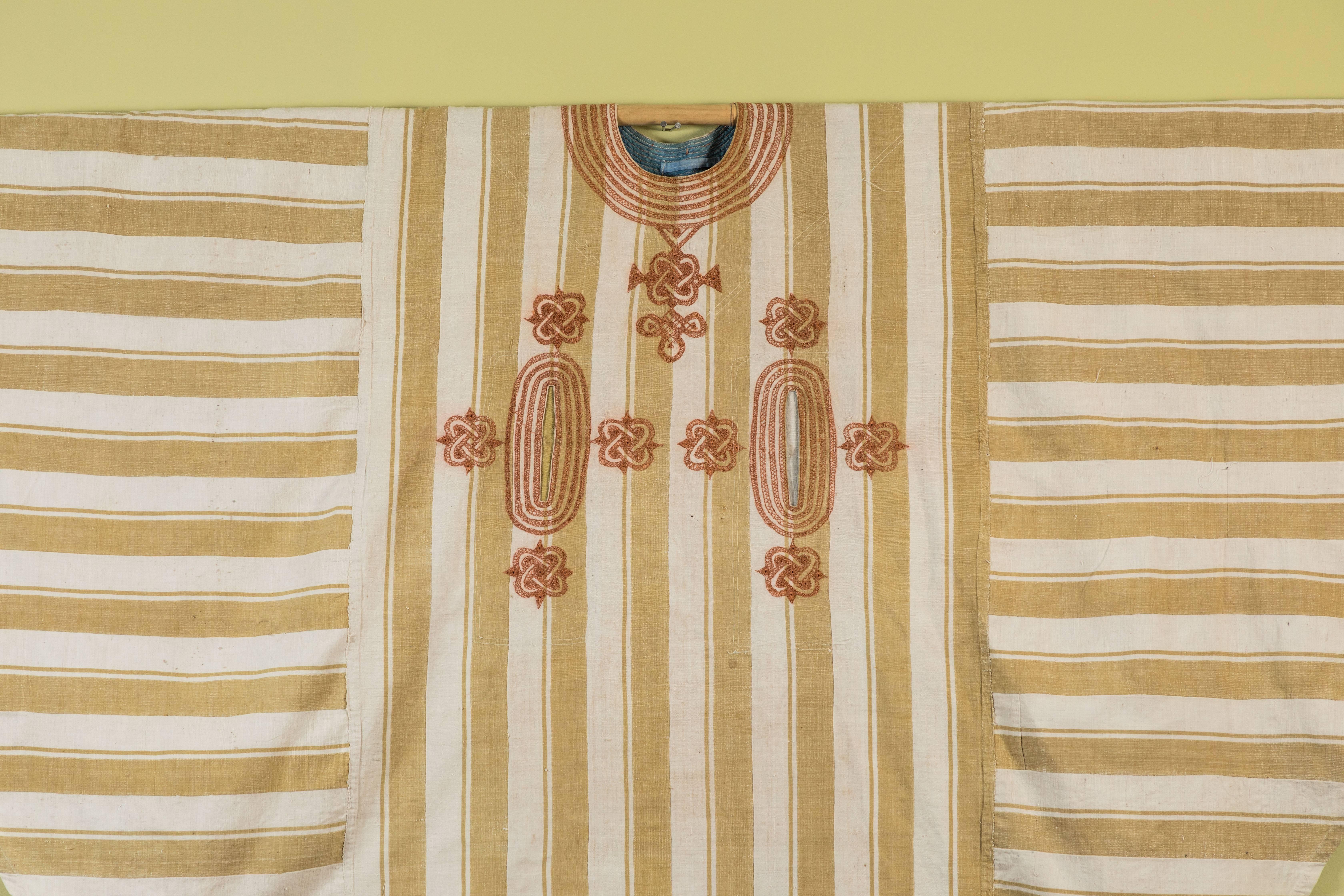 Nigerian embroidered cotton man's tunic. Offered by .