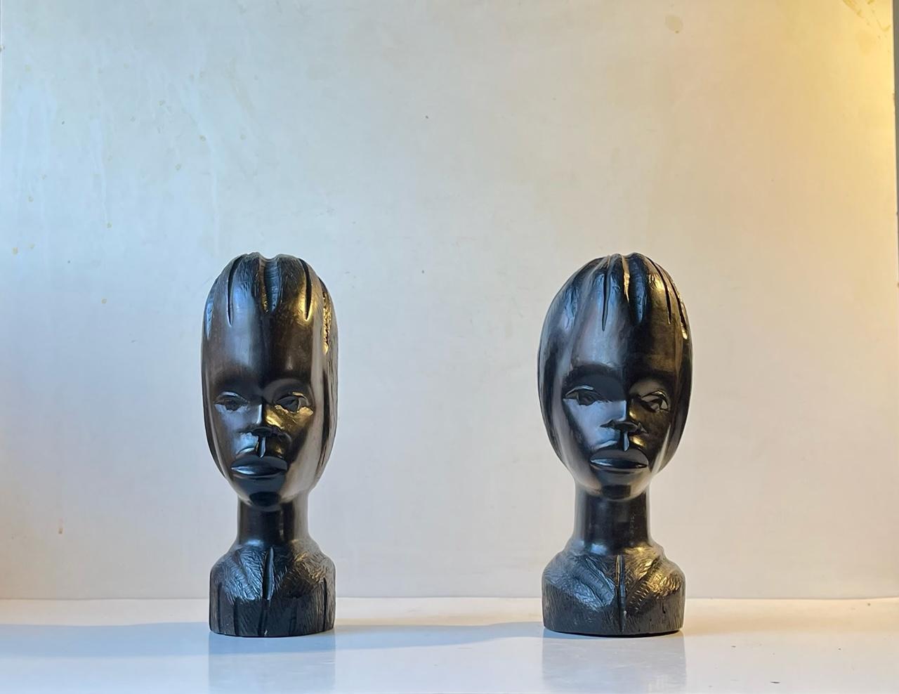 A set of vintage African Busts; boy and girl, possibly Nigerian/Lagos. Hand-carved from Ebony wood. Very decorative with a strong 'dark' and stylish presence. Due to their weight they would make a great pair of unusual bookends. Measurements: