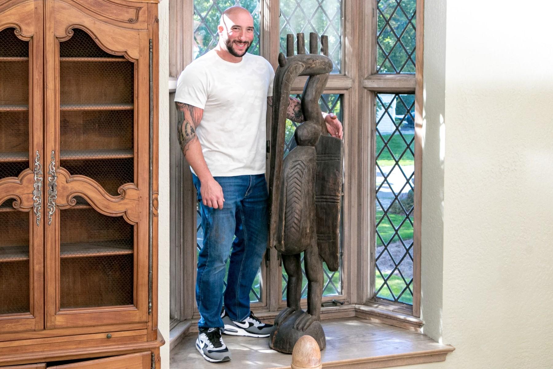 A 20th Century reproduction carved sculpture depicting a standing bird, supported on a domed base the feet extend to the legs with wings flared and bulbous belly. The craned neck with heat having flanges off the head with a long beak that extends