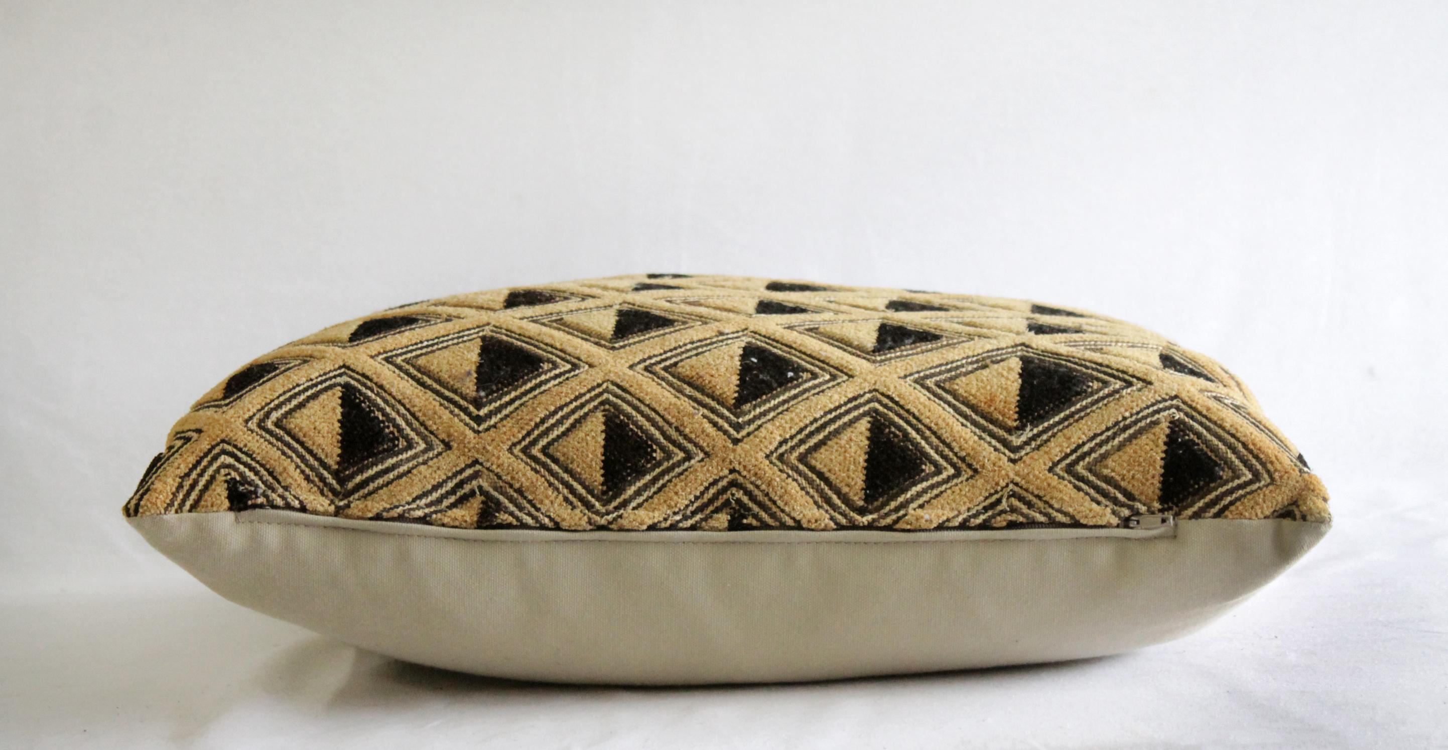 Vintage African Kuba Cloth pillow black and tan pattern, back side is natural cotton. 
Measures: 17