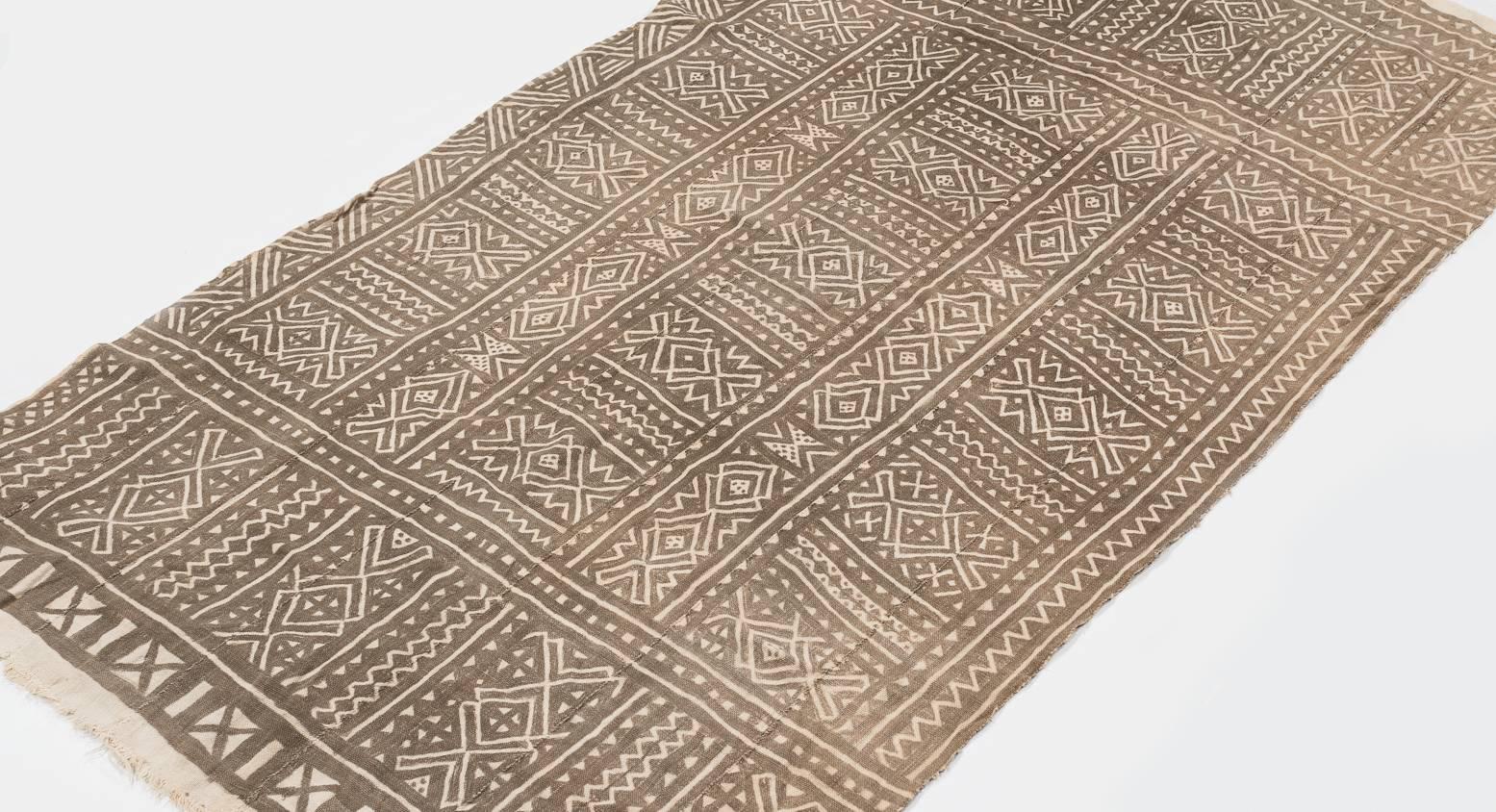 This mud cloth was made circa 1980s and was made from handwoven strips of cotton. This mud cloth comes from Mali and made by the Bamana tribe. The cotton is very soft. The pattern has intriguing subtle changes throughout that are not apparent at