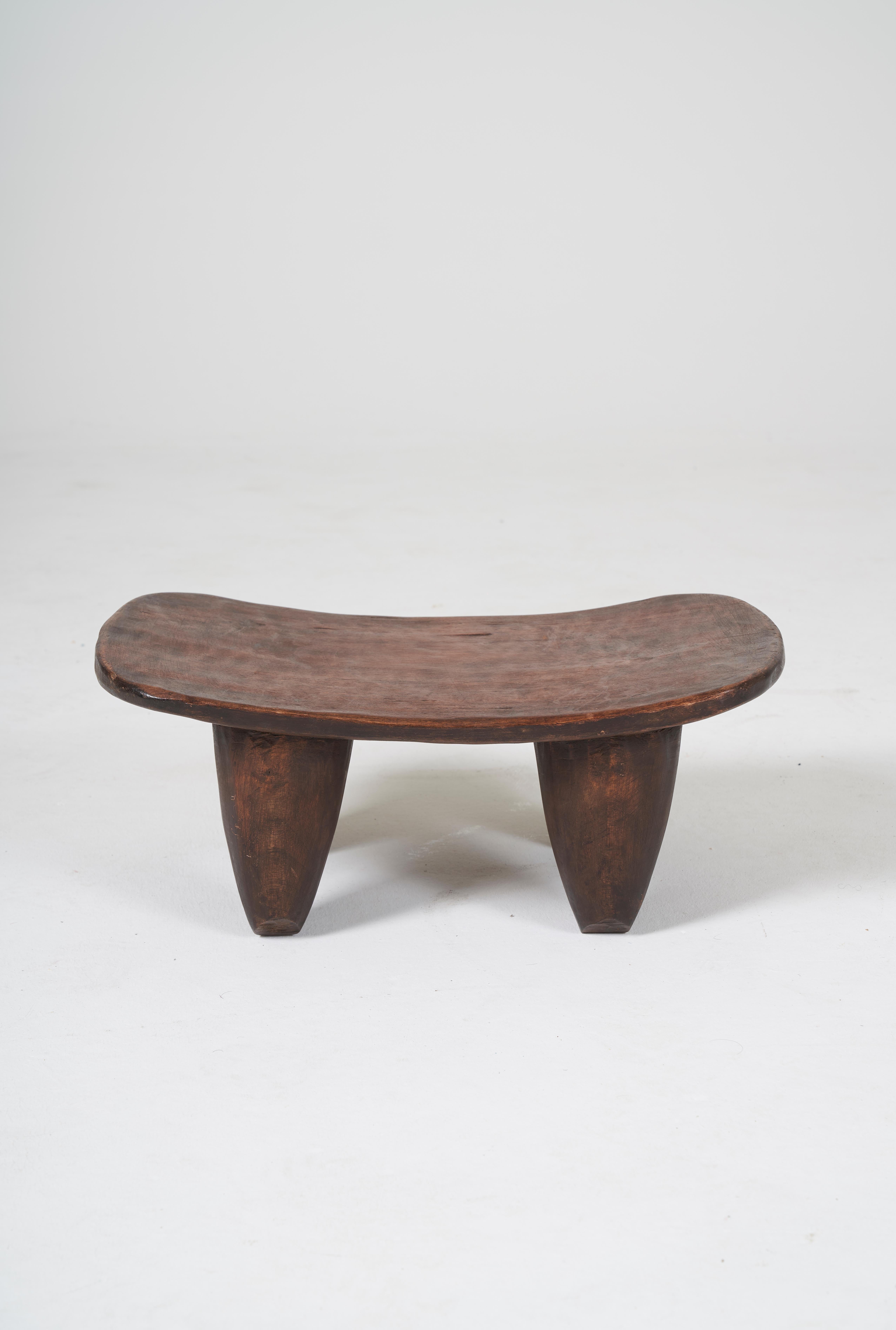 African Senoufo stool in wood hand carved by the Senoufo people of Ivory Coast. These stools, like family heirlooms in Western cultures, become more valuable in Africa as they age. A wonderful addition to any home collection. Beautiful patina of the