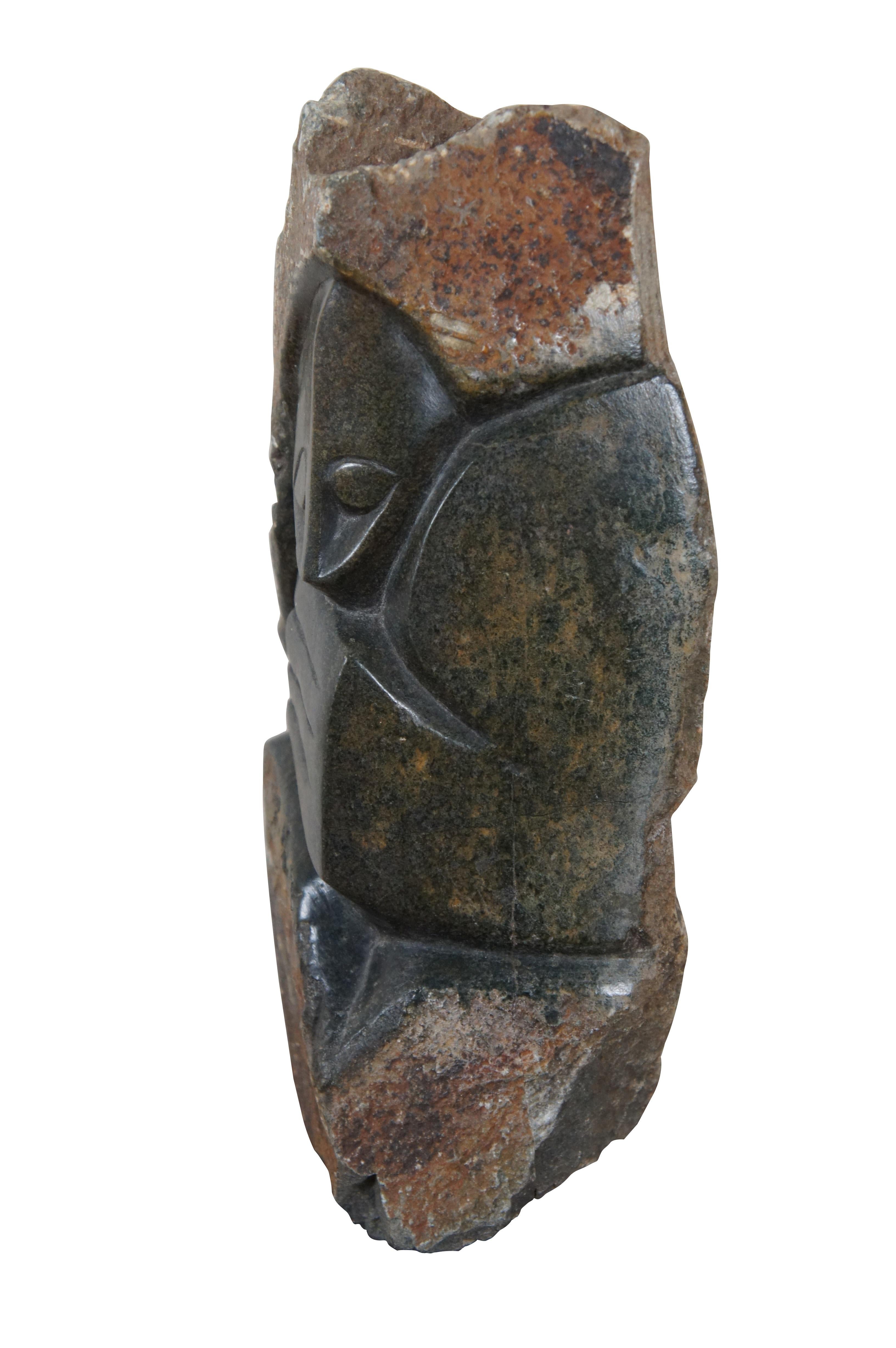 Vintage heavy African Shona folk art sculpture featuring an smoothly finished child with mothers hand / arm, nestled in a slab of unfinished granite rock.

“Shona sculpture is the name given to a modern movement of stone carved sculpture created in