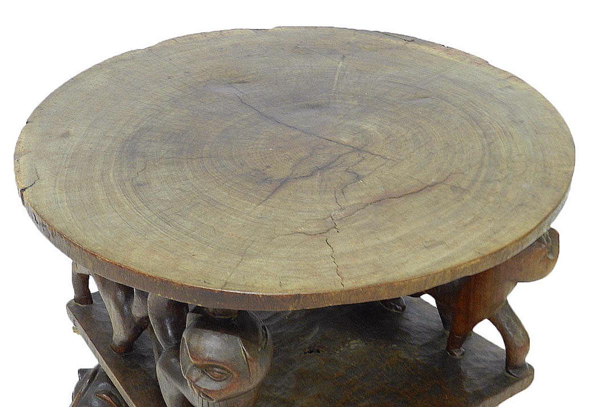 Vintage African carved wood table with animals, early 20th Century
Primitive figures and animals
Rough hewn live edge wood with superb patina
Two-tier side or coffee table
In very good condition for its age with a couple of very small losses to