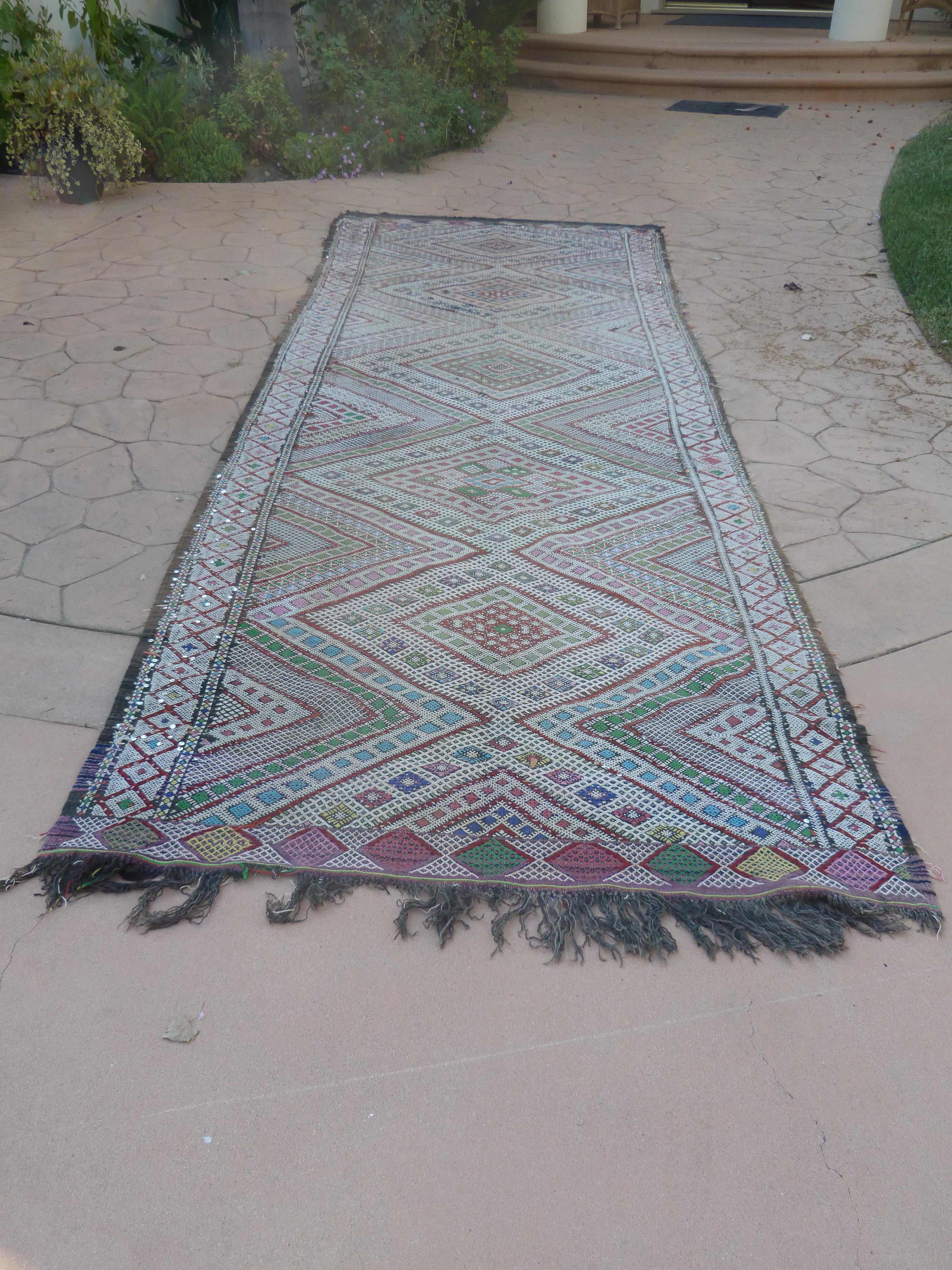 1960 authentic handwoven vintage clector African Moroccan Zemmour tribal runner rug.Intricate geometric designs on flat-weave Tuareg kilim rug, with some sequins.Great faded cors.Unique and beautif abstract work of Art, will add warm in a modernist