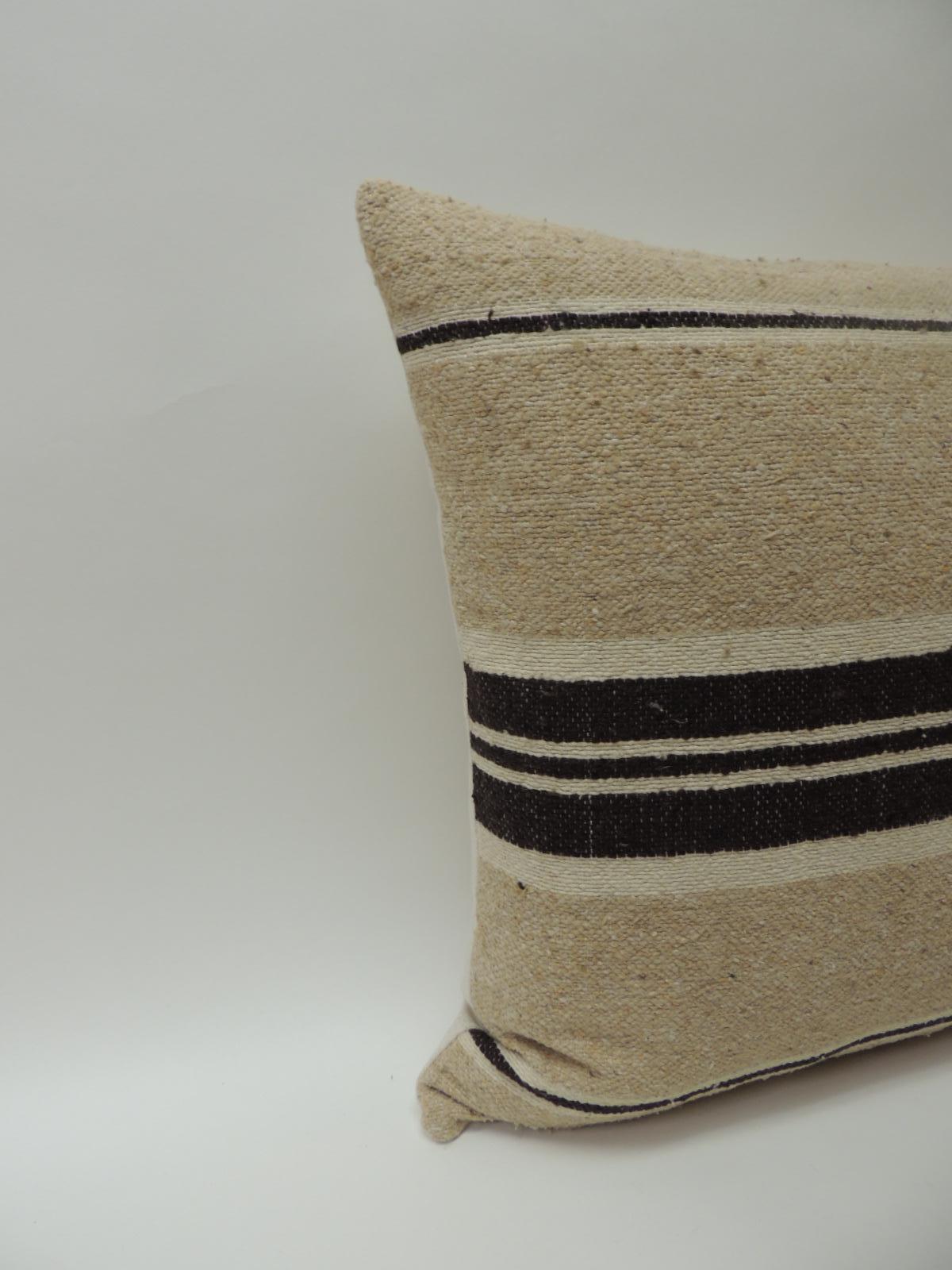 Vintage African woven tribal artisanal textile decorative pillow.
Tunisian vintage artisanal tribal textile decorative pillows handcrafted from the vintage wool and hemp hand-loomed by the Berber tribes from the Atlas Mountains of Morocco. Natural