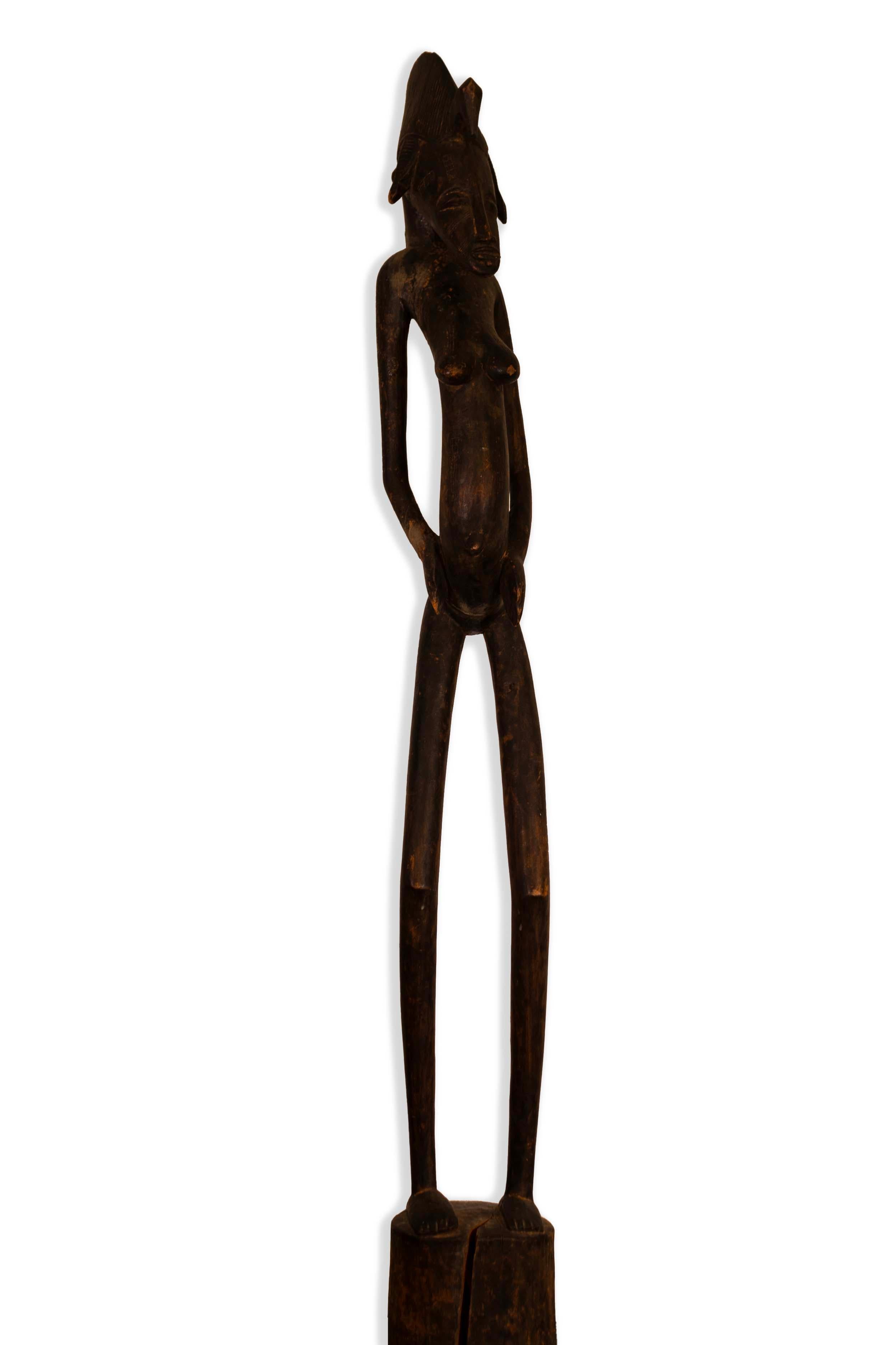 A monumental African female fertility standing sculpture associated with the Zulu people in South Africa. The female form is exquisitely carved in the teakwood. A unique collector’s item showcasing African art and history. From a private collection.