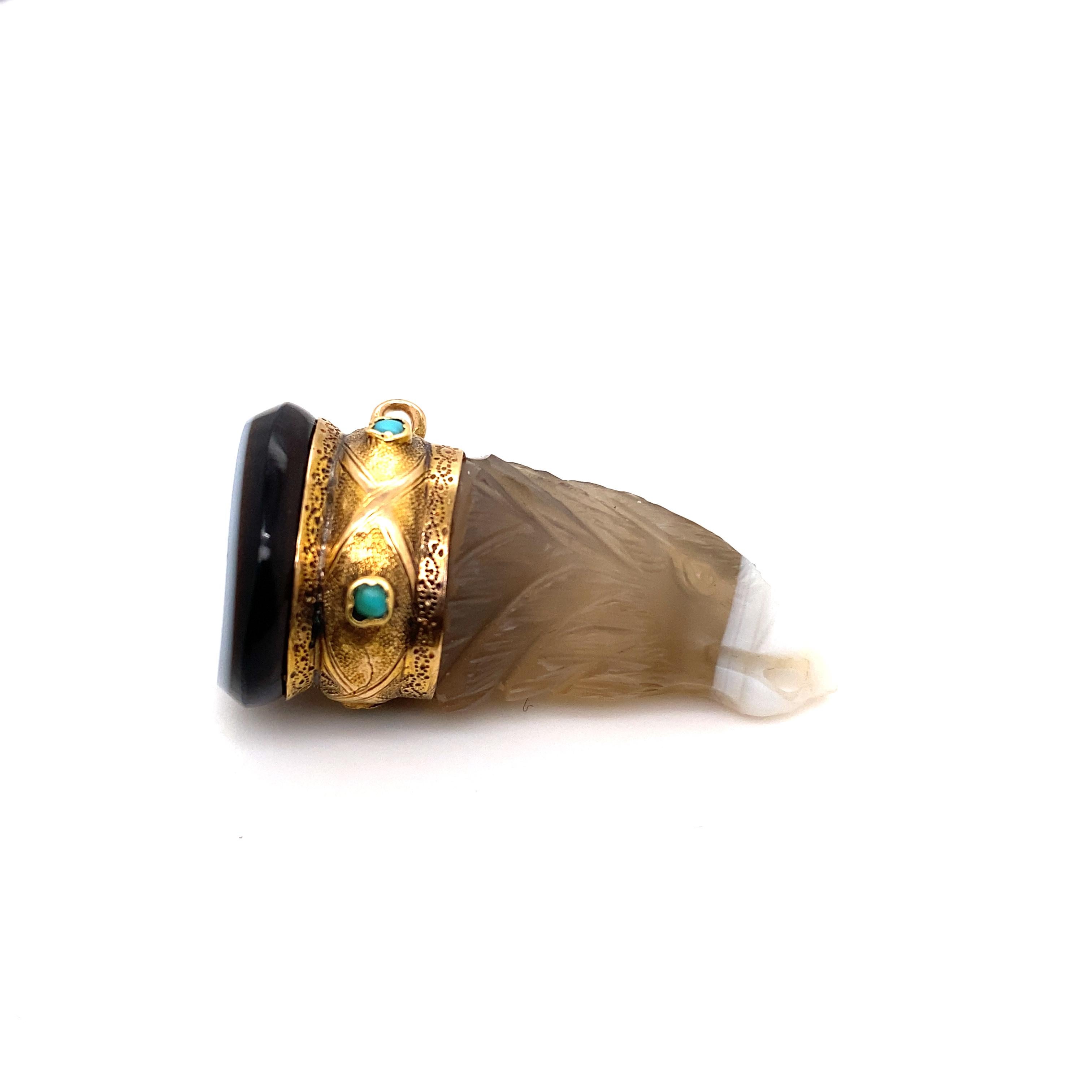 A vintage agate 18 karat yellow gold eagle fob, circa 1900.

This rare and unusual fob is realistically modelled as an eagle carved from one piece of banded agate.
The white section of banded agate is the beak of the bird of prey.

The eagle